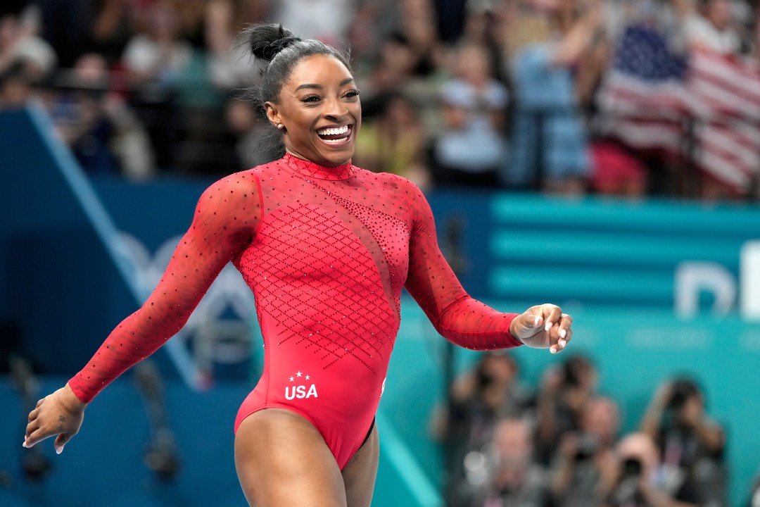 Simone Biles, of the United States, smiles after competing during the women's artistic gymnastics individual vault finals at Bercy Arena at the 2024 Summer Olympics, Saturday, Aug. 3, 2024, in Paris, France. (AP Photo/Charlie Riedel)