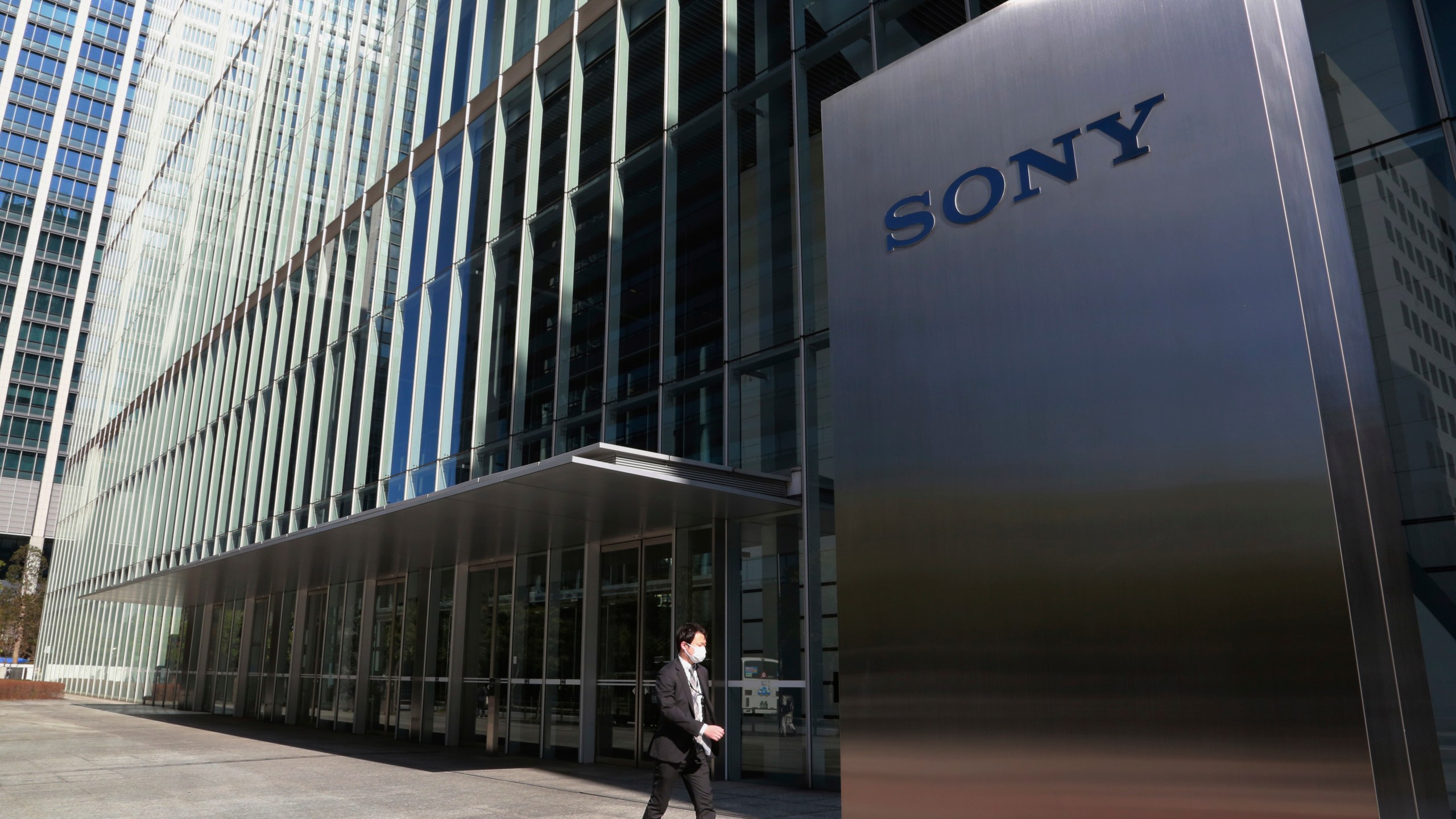 FILE - A man walks past the headquarters of Sony Corp. in Tokyo, on Feb. 3, 2021. (AP Photo/Koji Sasahara, File)
