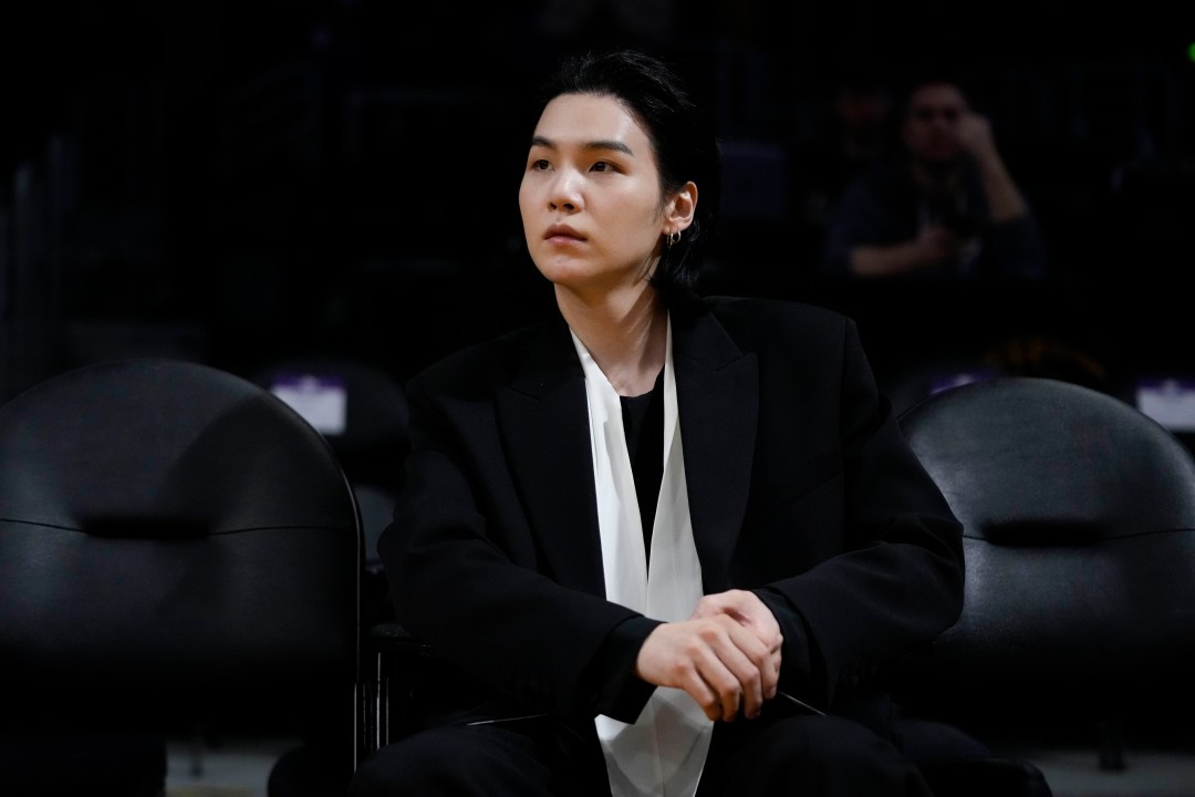 FILE - BTS member Suga attends an NBA basketball game between the Los Angeles Lakers and the Dallas Mavericks on Jan. 12, 2023, in Los Angeles. (AP Photo/Jae C. Hong, File)