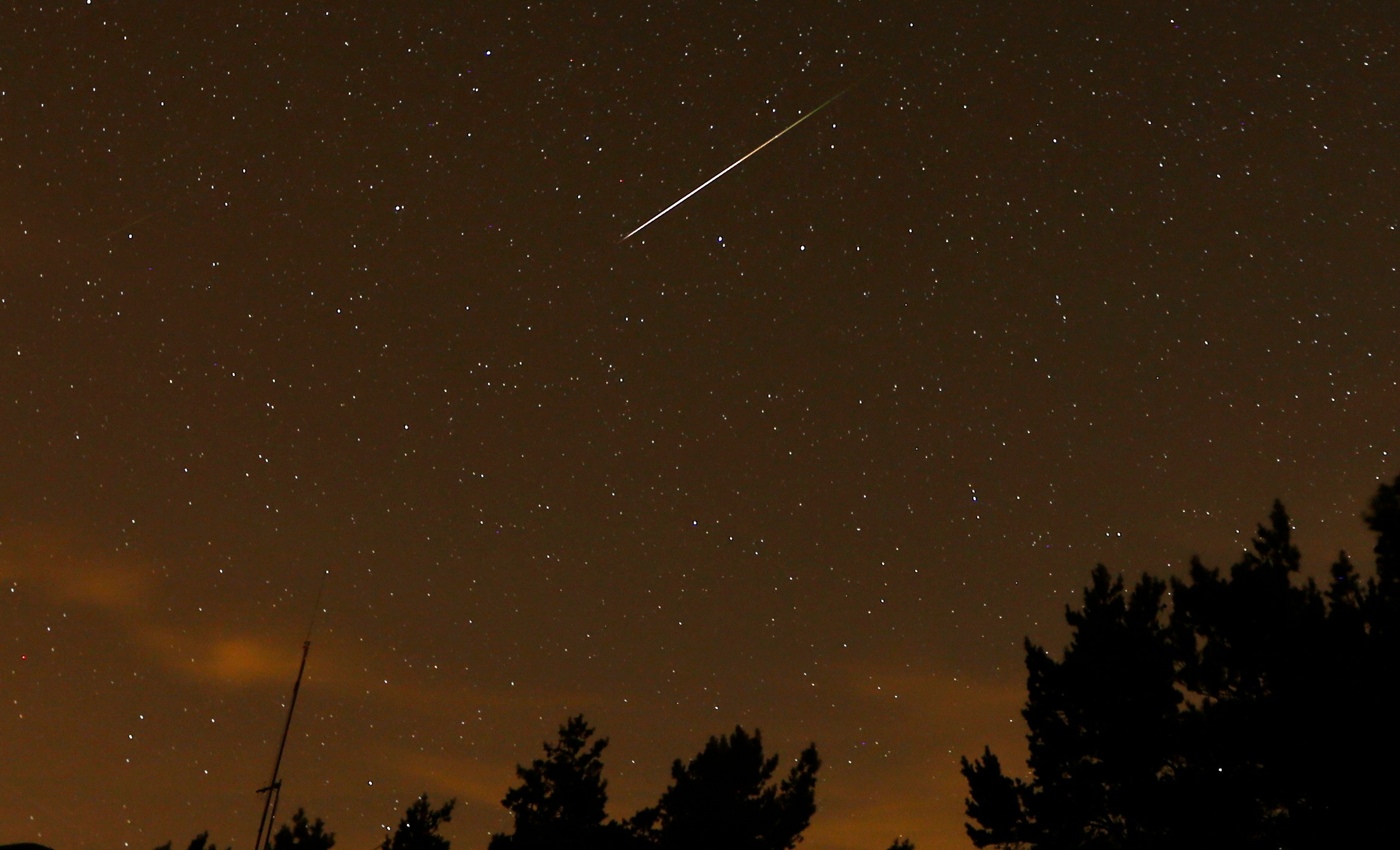FILE - In this long exposure photo, a streak appears in the sky during the annual Perseid meteor shower at the Guadarrama mountains, near Madrid, in the early hours of Aug. 12, 2016. (AP Photo/Francisco Seco, File)