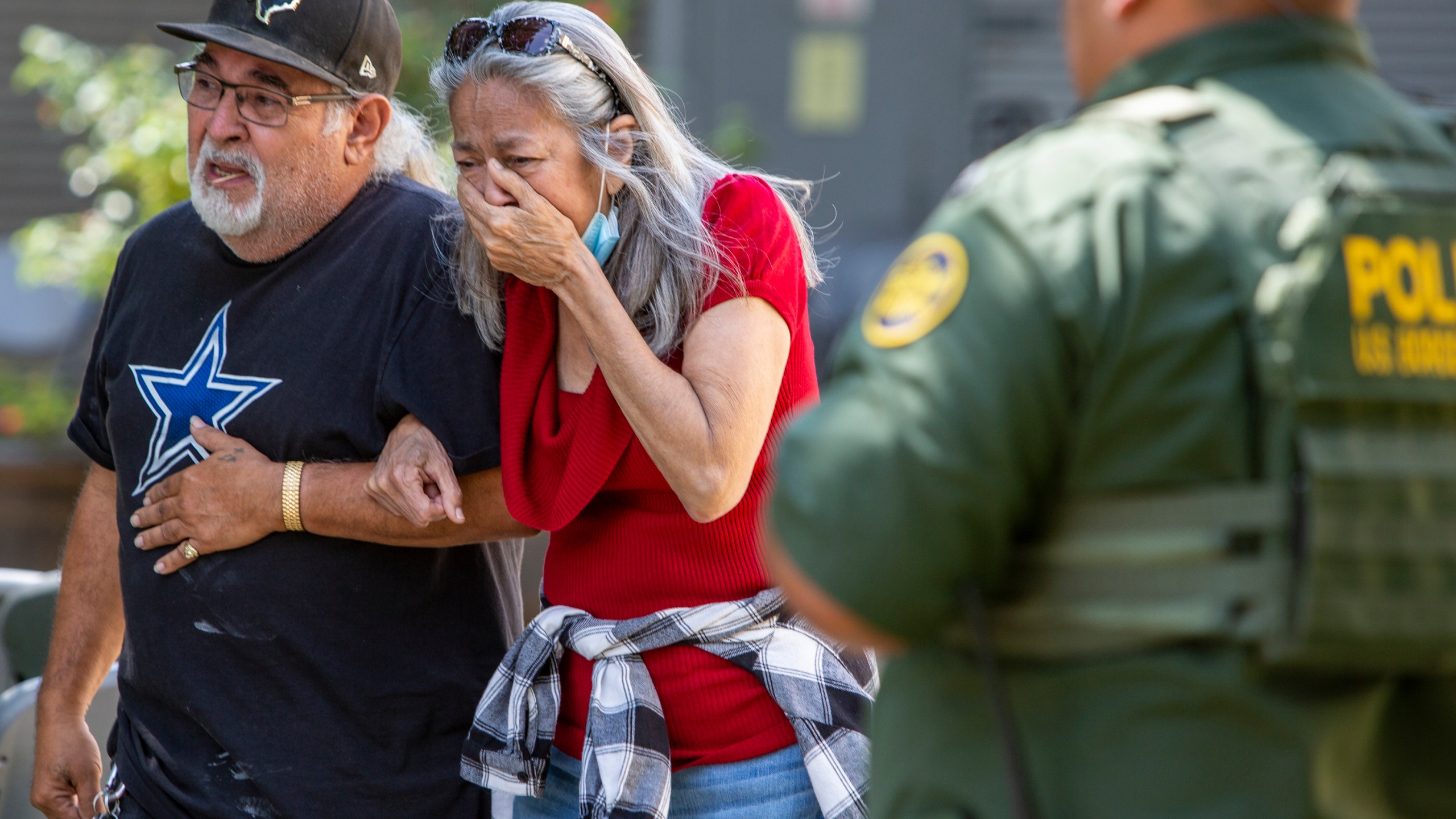 FILE - A woman cries as she leaves the Uvalde Civic Center after shooting a was reported earlier in the day at Robb Elementary School, Tuesday, May 24, 2022, in Uvalde, Texas. (William Luther/The San Antonio Express-News via AP)
