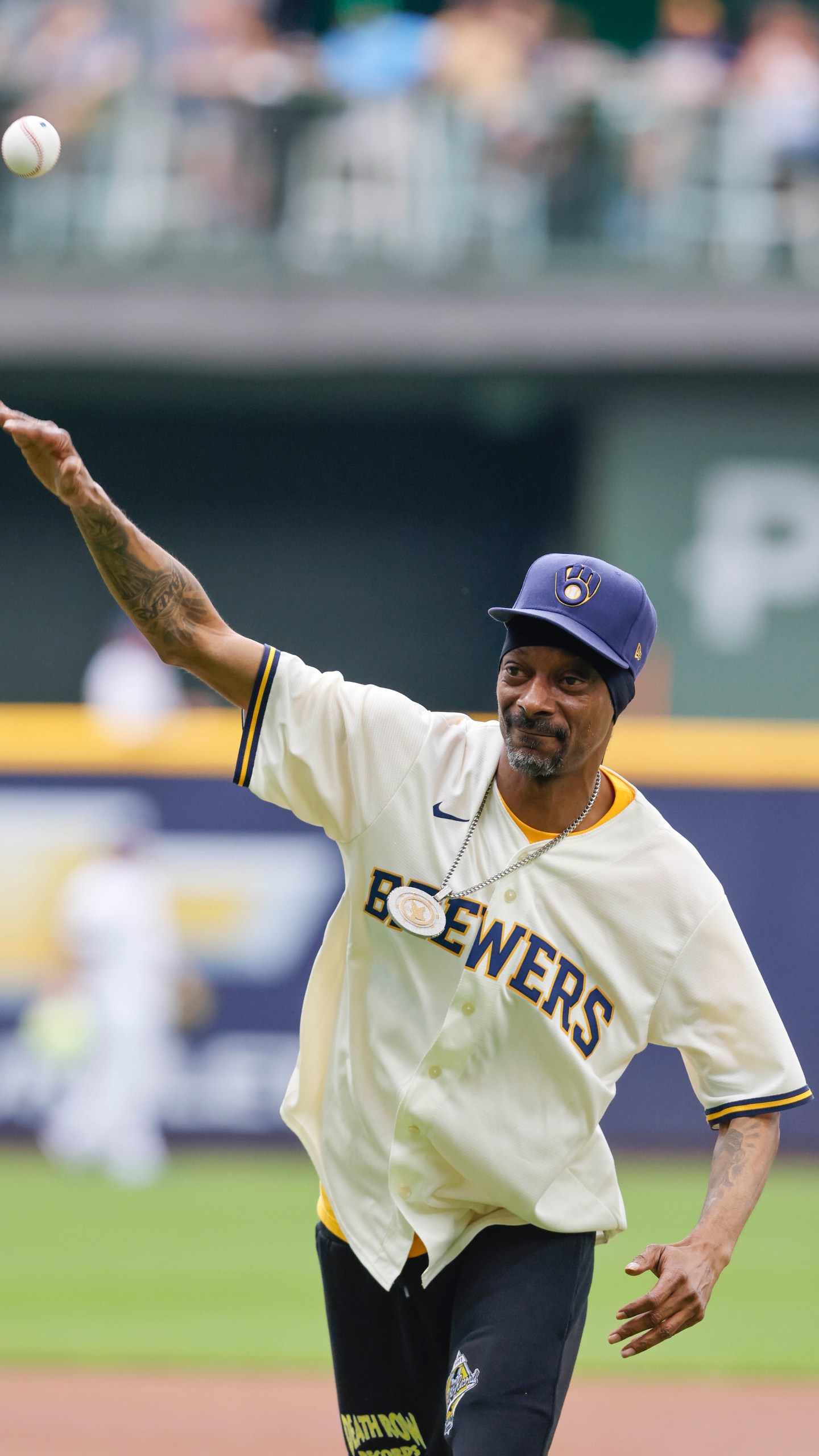 FILE - Snoop Dogg throws out the ceremonial first pitch before a baseball game between the Milwaukee Brewers and the Cincinnati Reds Saturday, June 15, 2024, in Milwaukee. (AP Photo/Jeffrey Phelps, File)