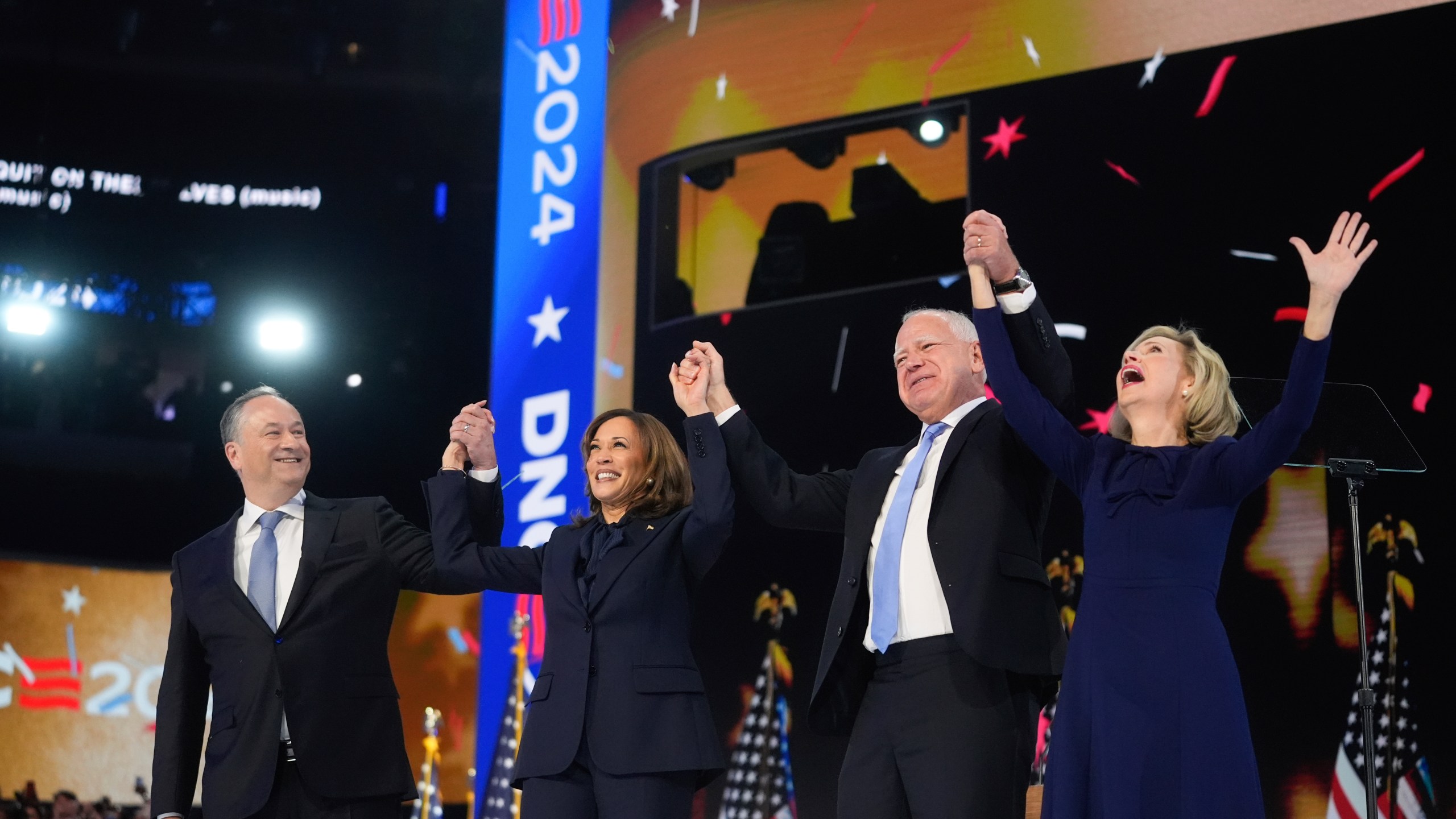 Democratic presidential nominee Vice President Kamala Harris with Second gentleman Douglas Emhoff and Democratic vice presidential candidate Minnesota Gov. Tim Walz with his wife Gwen Walz celebrate during the Democratic National Convention Thursday, Aug. 22, 2024, in Chicago. (AP Photo/Erin Hooley)