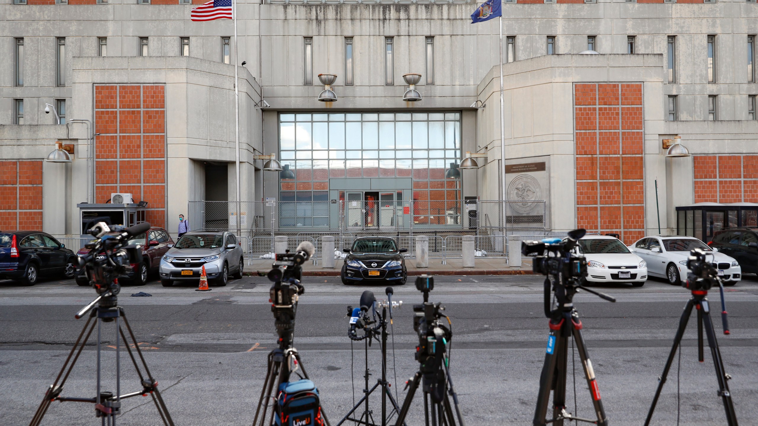 FILE - Media outlets set up cameras outside the main entrance of the Metropolitan Detention Center Tuesday, July 14, 2020, in the Brooklyn borough of New York. (AP Photo/John Minchillo, File)