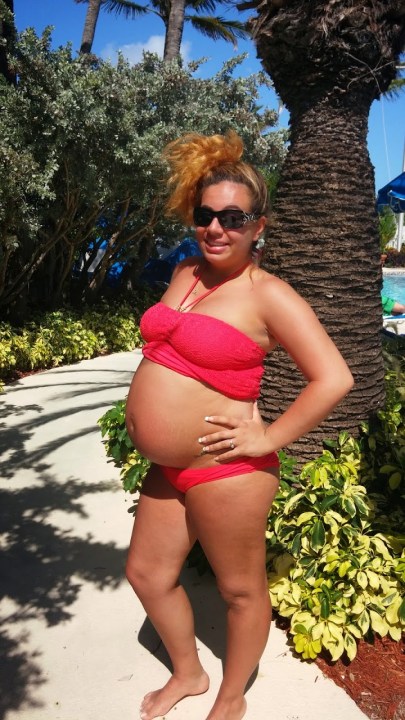 A pregnant woman in a red bikini