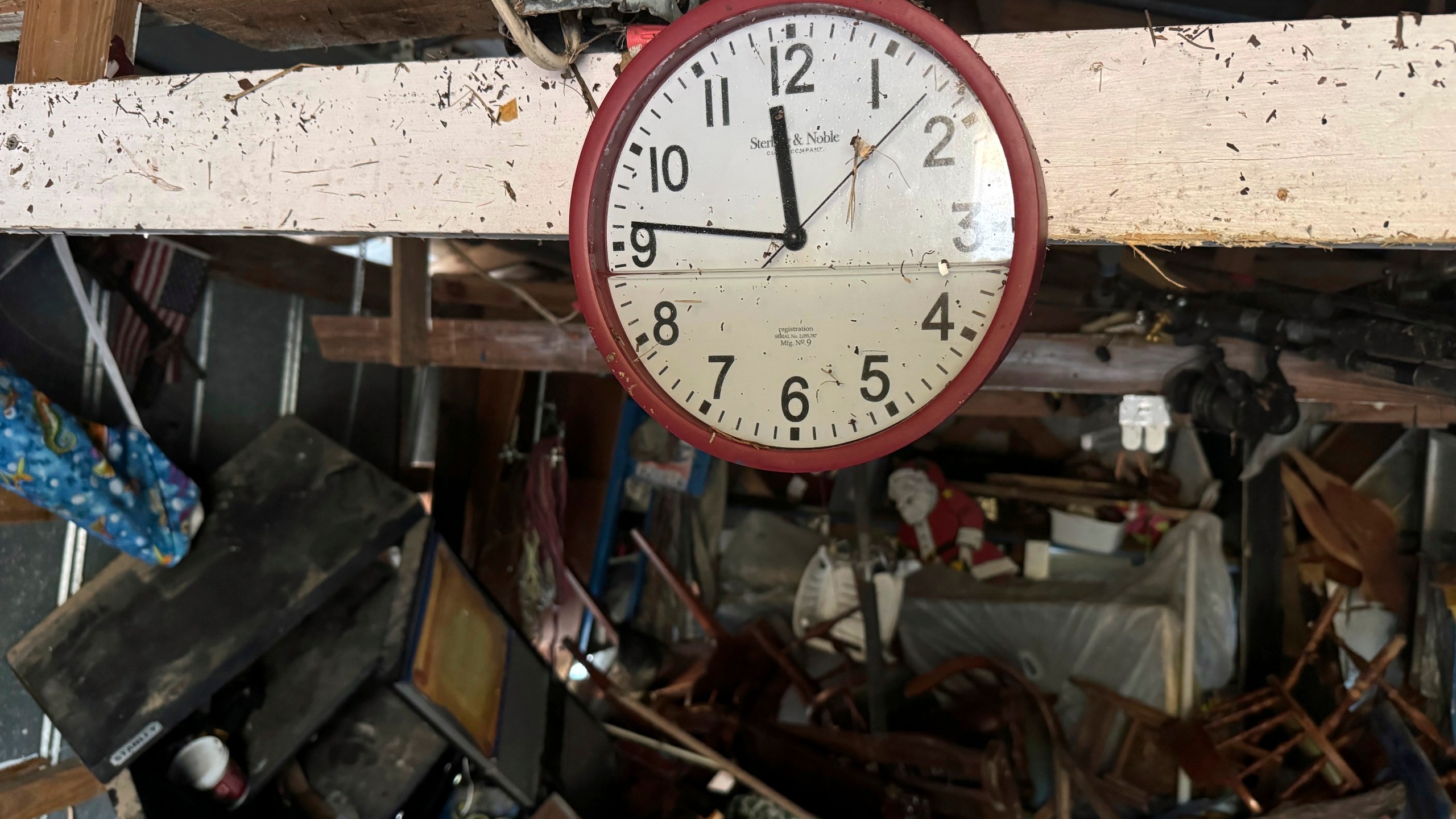 A waterlogged clock hangs a shed, Sunday, Sept 29, 2024, in Steinhatchee, Fla., in the aftermath of Hurricane Helene. (AP Photo/Kate Payne)