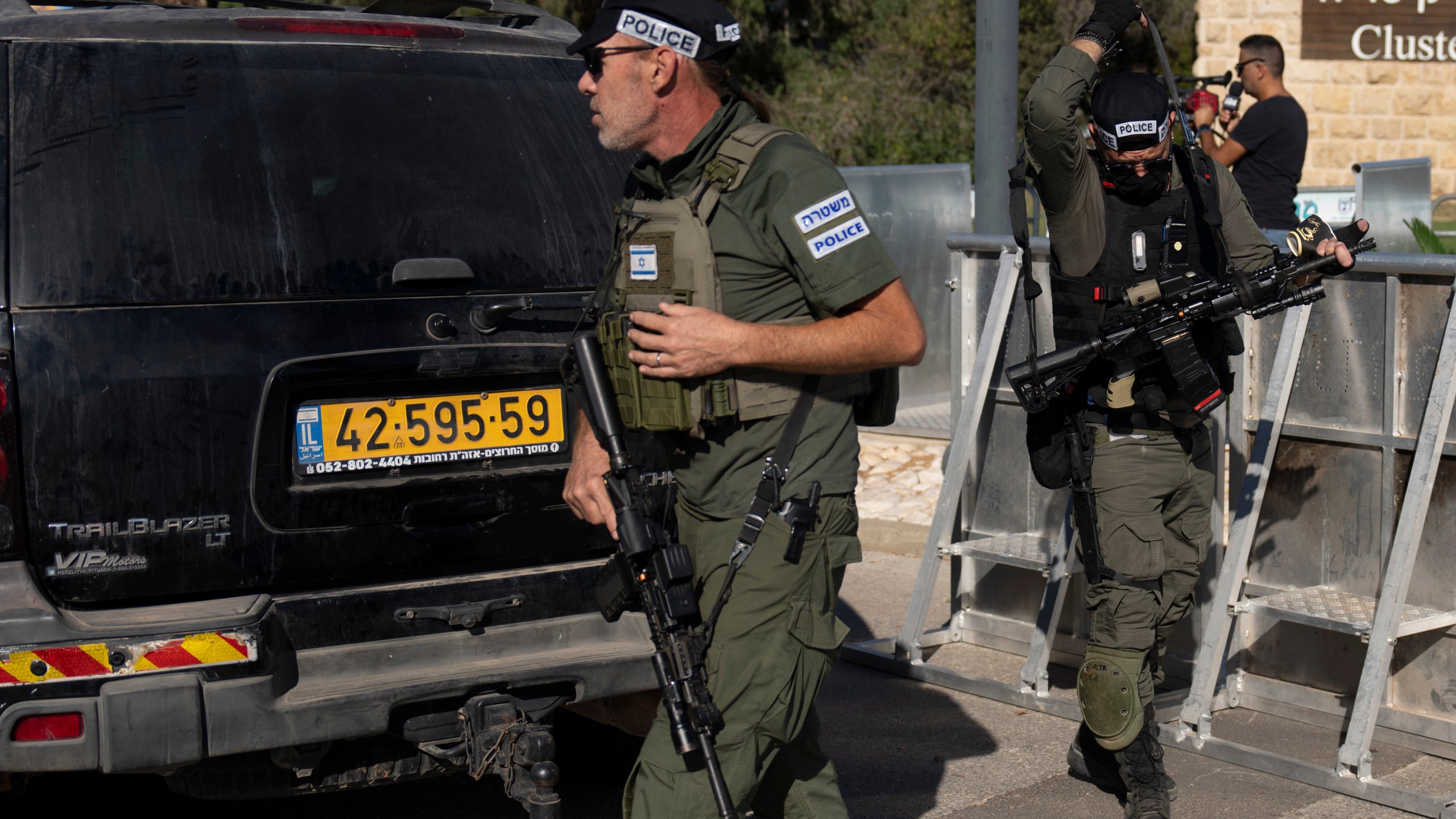 Israeli security forces secure a road near where Israel's government says a drone launched toward Israeli Prime Minister Benjamin Netanyahu's house in Caesarea, Israel Saturday, Oct. 19, 2024. (AP Photo/Ariel Schalit)