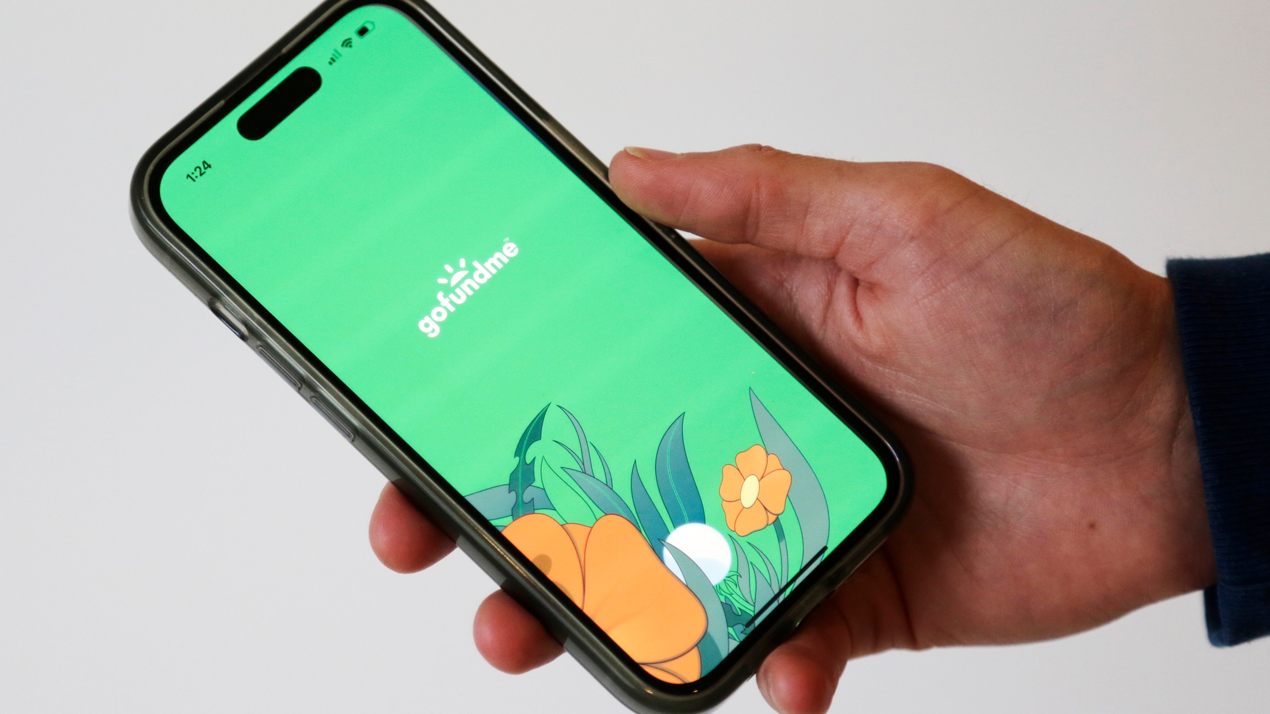 The home page for the crowdfunding platform GoFundMe is shown on a cellphone