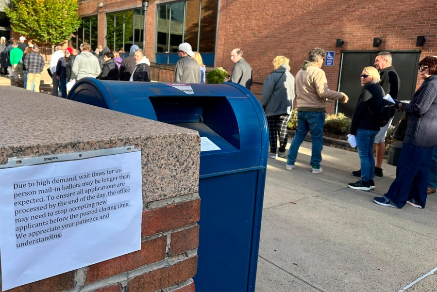 People wait in line outside the Bucks County government building to apply for an on-demand mail ballot in Pennsylvania.