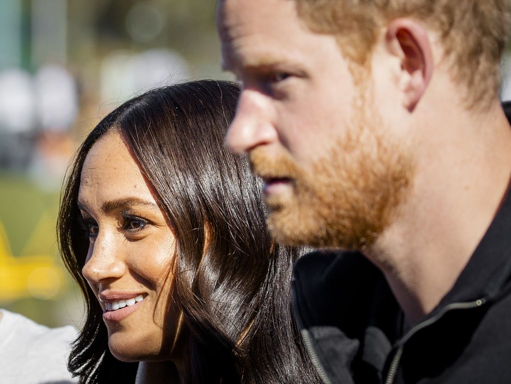 Meghan and Harry speak during an event