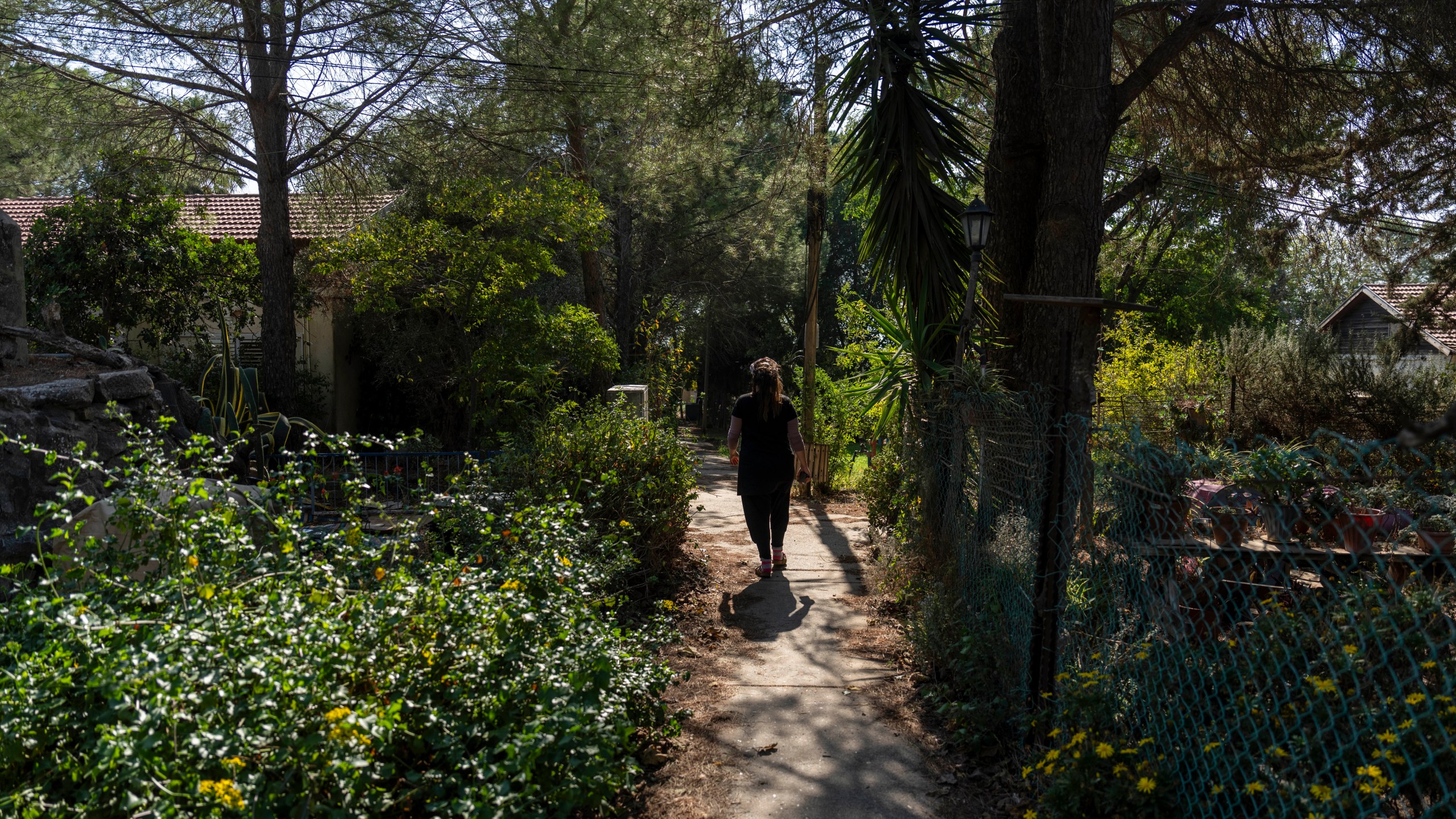 A woman walks in the tiny settlement of "Trump Heights" in the Israeli-controlled Golan Heights, where residents are welcoming the election of their namesake. They hope Donald Trump's return to the U.S. presidency will breathe new life into the community. Thursday, Nov. 7, 2024. (AP Photo/Ariel Schalit)