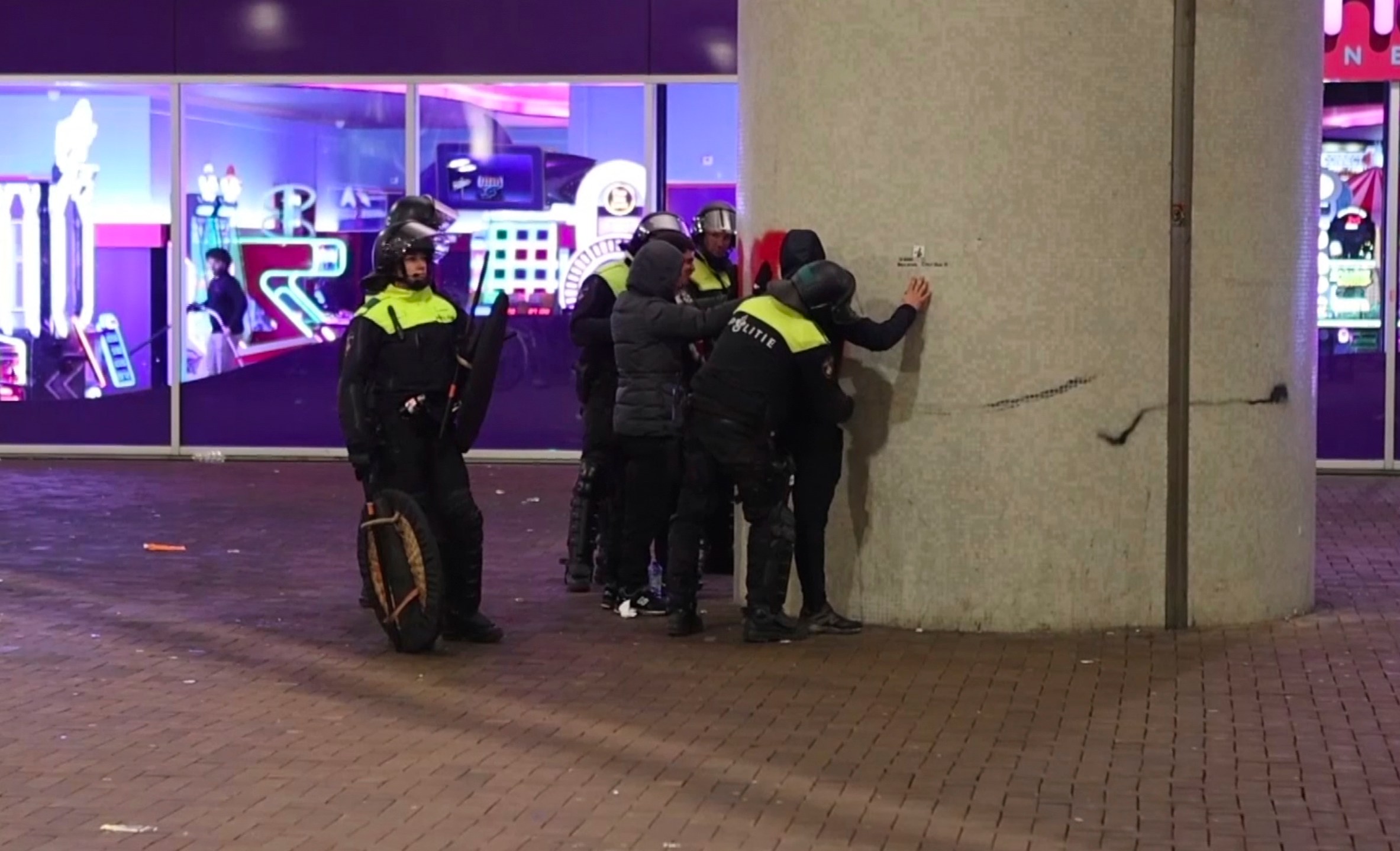 In this image taken from video, police frisk pro-Palestinian supporters near the Ajax stadium in Amsterdam, the Netherlands, Thursday, Nov. 7, 2024. (AP Photo InterVision)