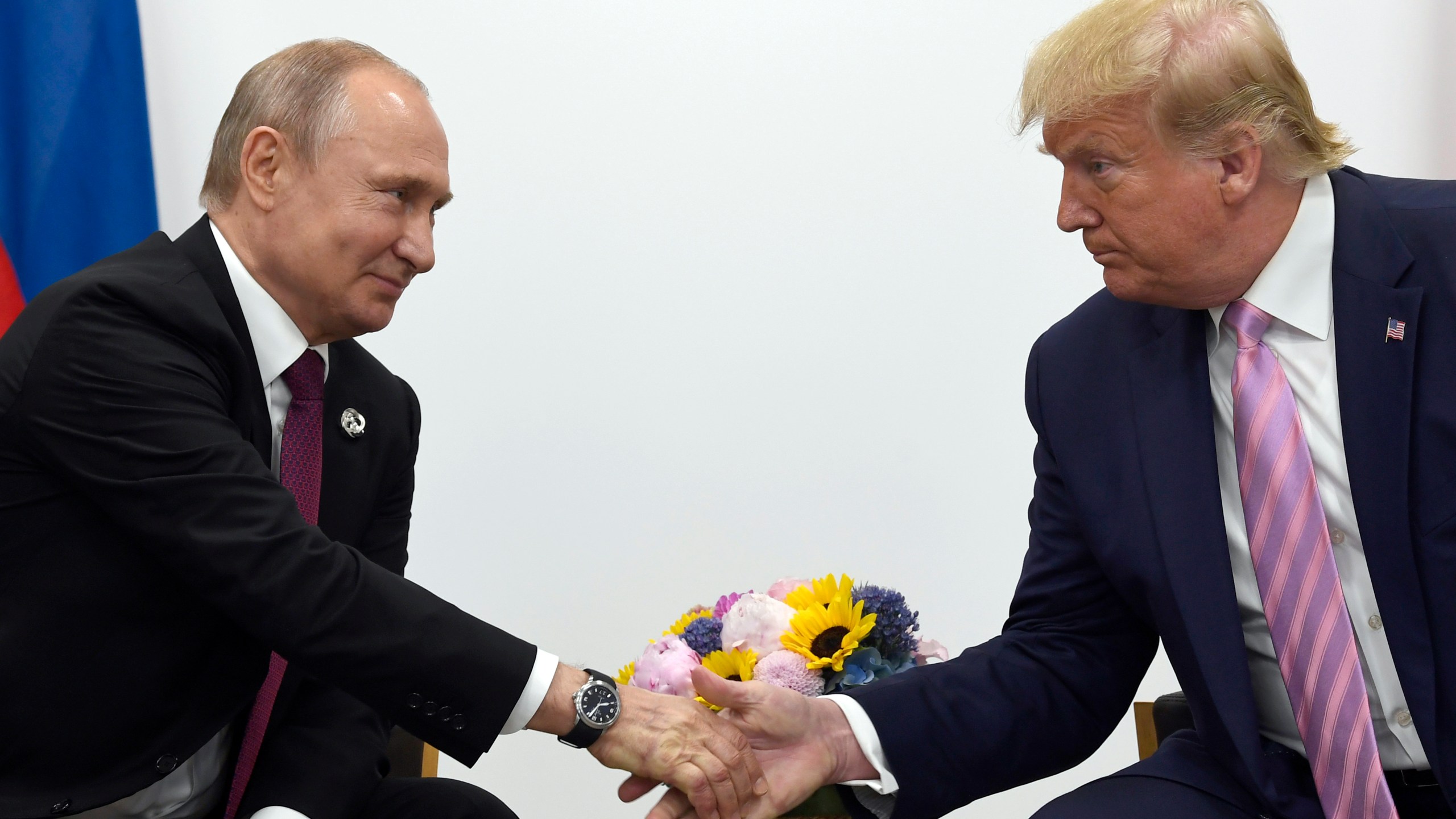 Trump and Putin shake hands
