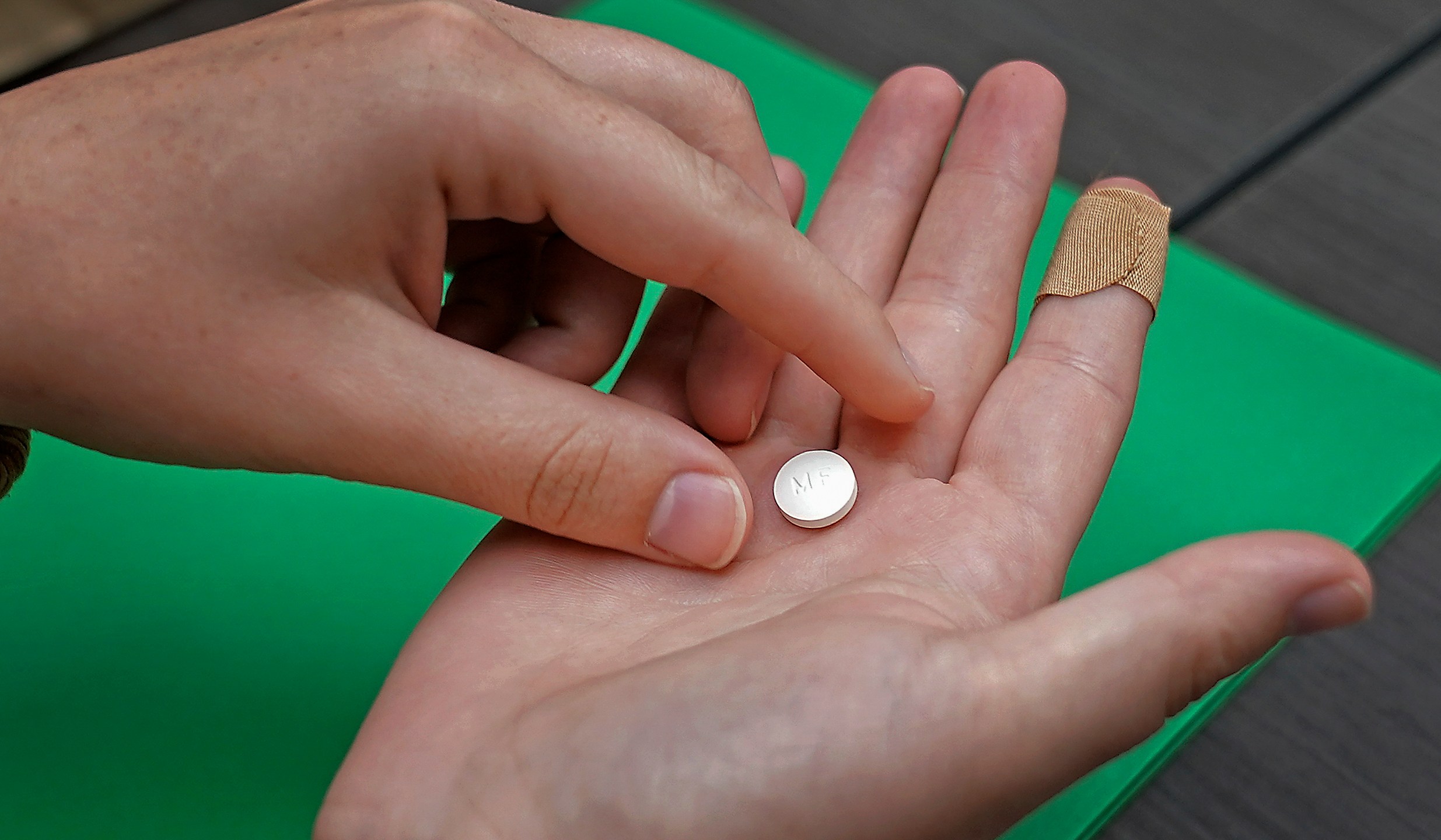 FILE - A patient prepares to take the first of two combination pills, mifepristone, for a medication abortion during a visit to a clinic in Kansas City, Kan., Oct. 12, 2022. (AP Photo/Charlie Riedel, File)