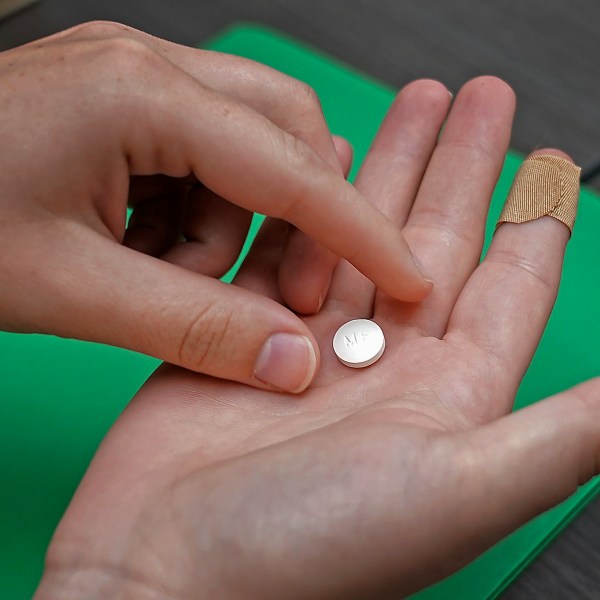 FILE - A patient prepares to take the first of two combination pills, mifepristone, for a medication abortion during a visit to a clinic in Kansas City, Kan., Oct. 12, 2022. (AP Photo/Charlie Riedel, File)