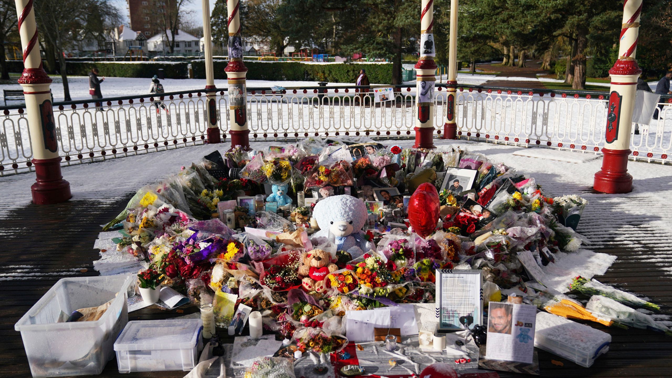 Flowers, portraits and toys lay in the ground for memory of the One Direction star singer Liam Payne at a memorial in West Park in his hometown of Wolverhampton, England, Wednesday, Nov. 20, 2024. (Jacob King/PA via AP)