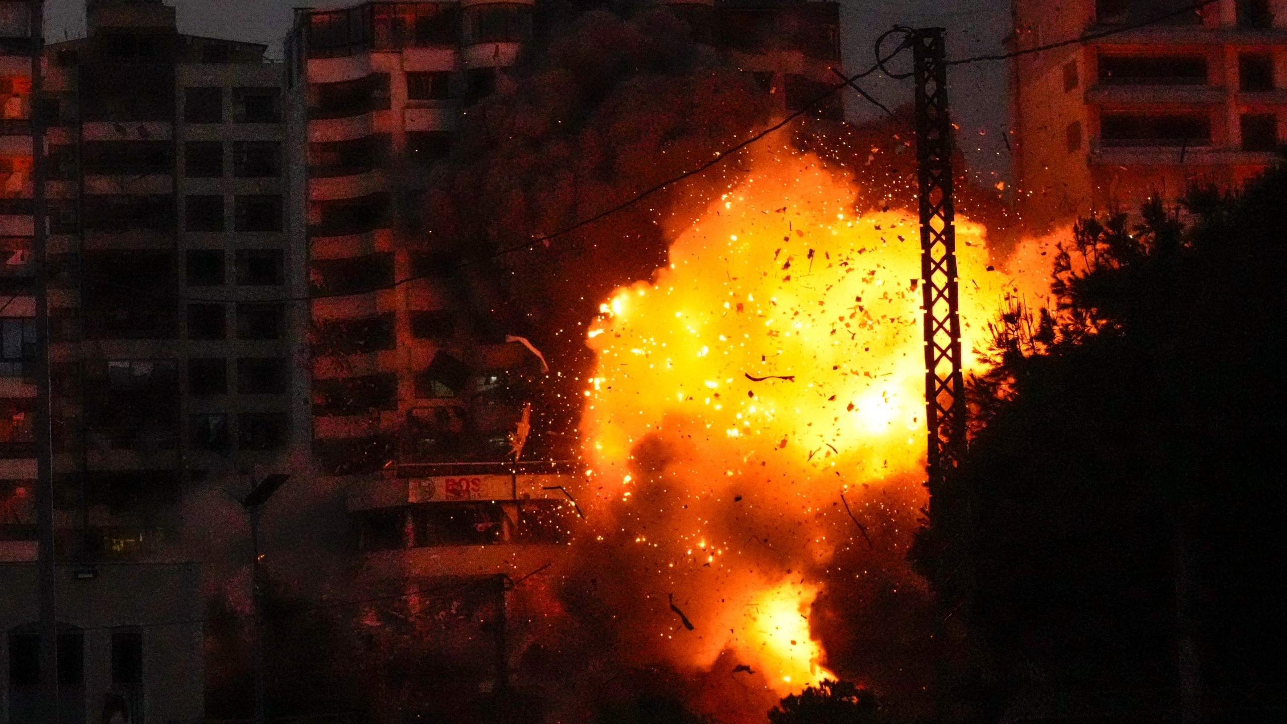 Thick smoke, flames and debris erupt from an Israeli airstrike that targeted a building in Tayouneh, Beirut, Lebanon, Monday, Nov. 25, 2024. (AP Photo/Hassan Ammar)