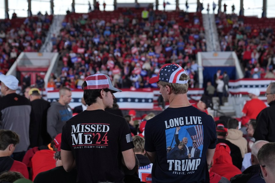 Two men wait at a rally for Donald Trump to arrive at a campaign rally in Pennsylvania on Nov. 4, 2024.