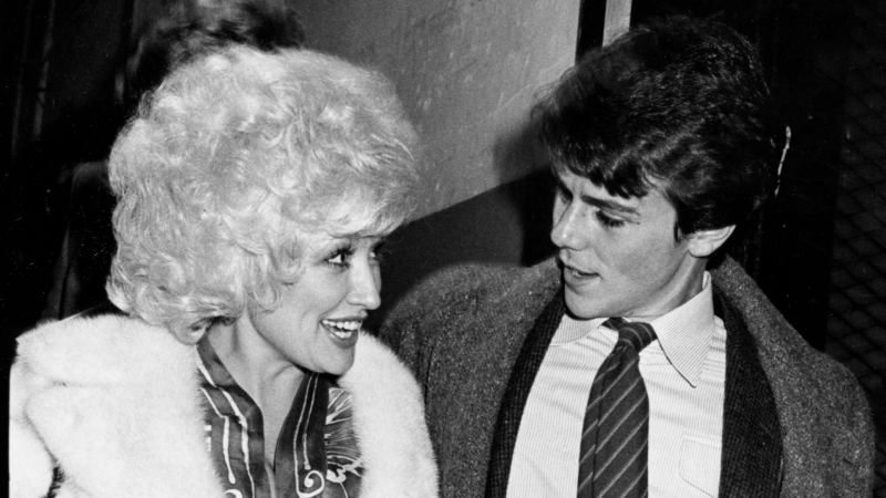 Dolly Parton and brother David Parton talk at a theater