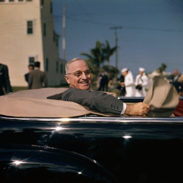 President Harry S. Truman chats from an open-top car in Key West, Florida in 1947.