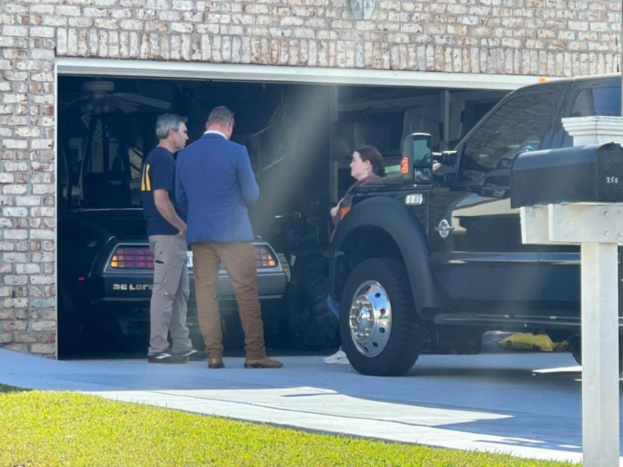 Agents standing in front of a garage.