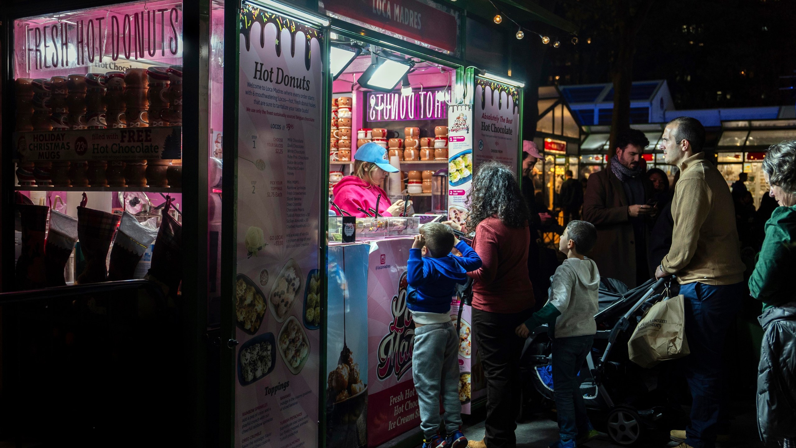 FILE - People wait in line for hot donuts at Bryant Park's Winter Village, Tuesday, Nov. 26, 2024, New York. (AP Photo/Julia Demaree Nikhinson, File)
