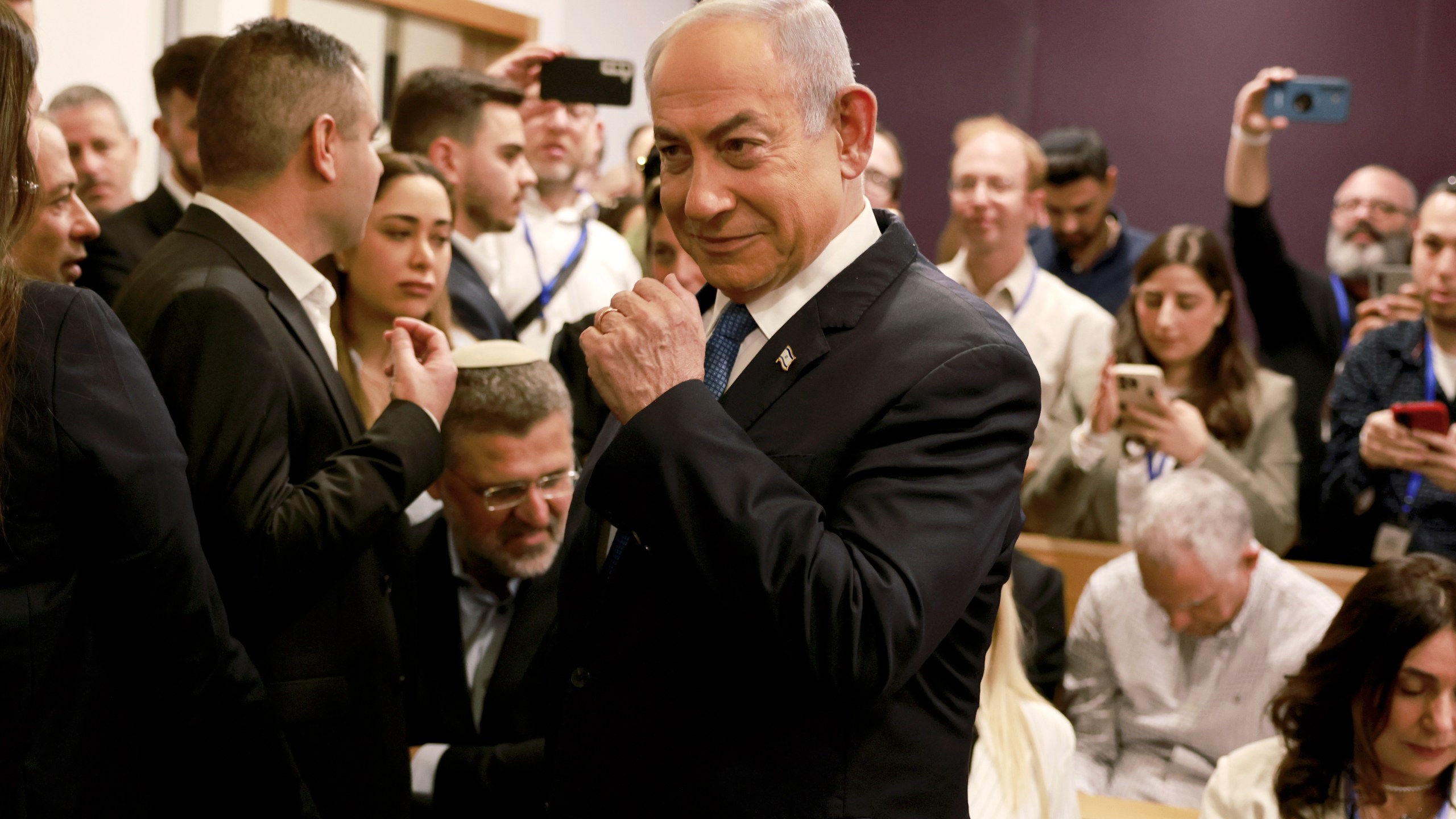 Israeli Prime Minister Benjamin Netanyahu arrives at the district court in Tel Aviv for his long-running trial for alleged corruption, in Tel Aviv, Israel, Tuesday, Dec. 10, 2024. (Menahem Kahana/Pool Photo via AP)