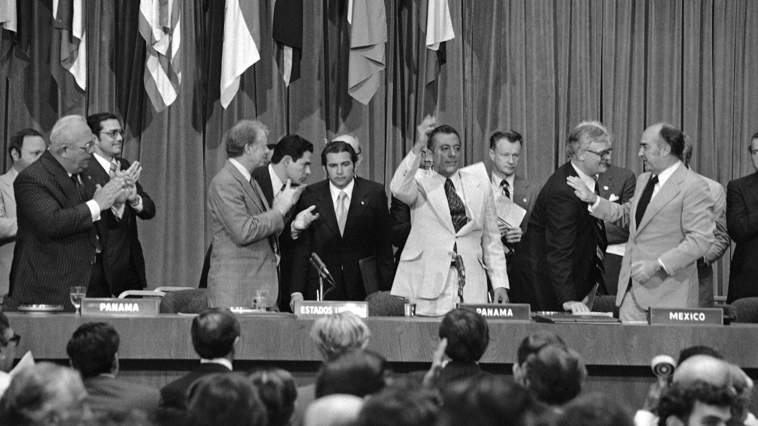 FILE - President Jimmy Carter applauds as General Omar Torrijos waves after the signing and exchange of treaties in Panama City on June 16, 1978, giving control of the Panama Canal to Panama in 2000. At far right is Zbigniew Brzezinski, Carterís National Security Advisor. (AP Photo, File)