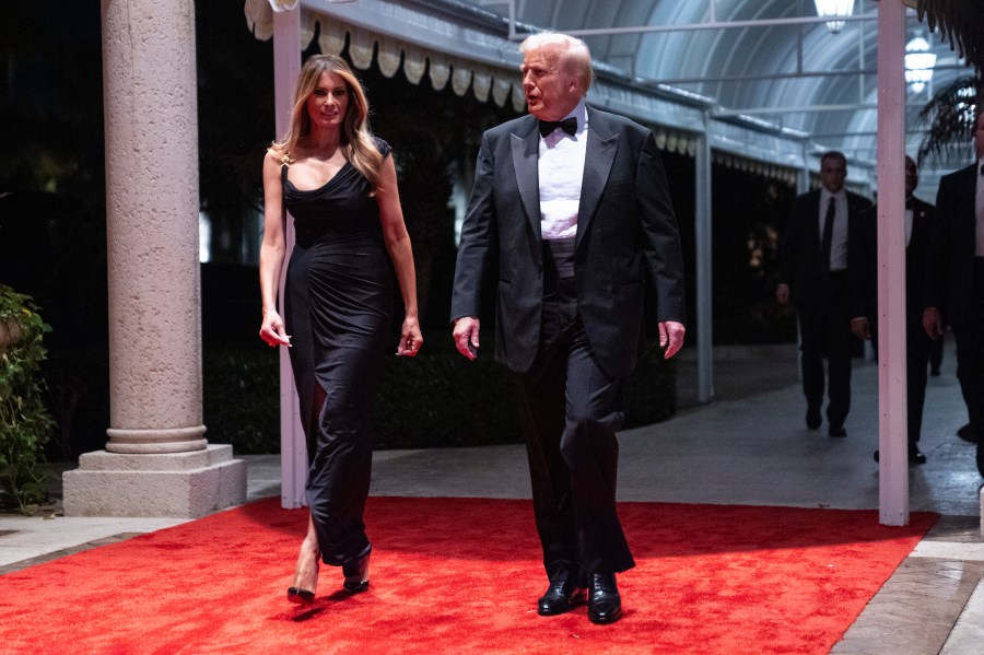 Melania Trump looks on as President-elect Donald Trump arrives for a New Year's Eve party at Mar-a-Lago, Tuesday, Dec. 31, 2024, in Palm Beach, Fla. (AP Photo/Evan Vucci)