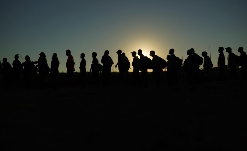 Migrants are lined up for processing at the U.S. border.