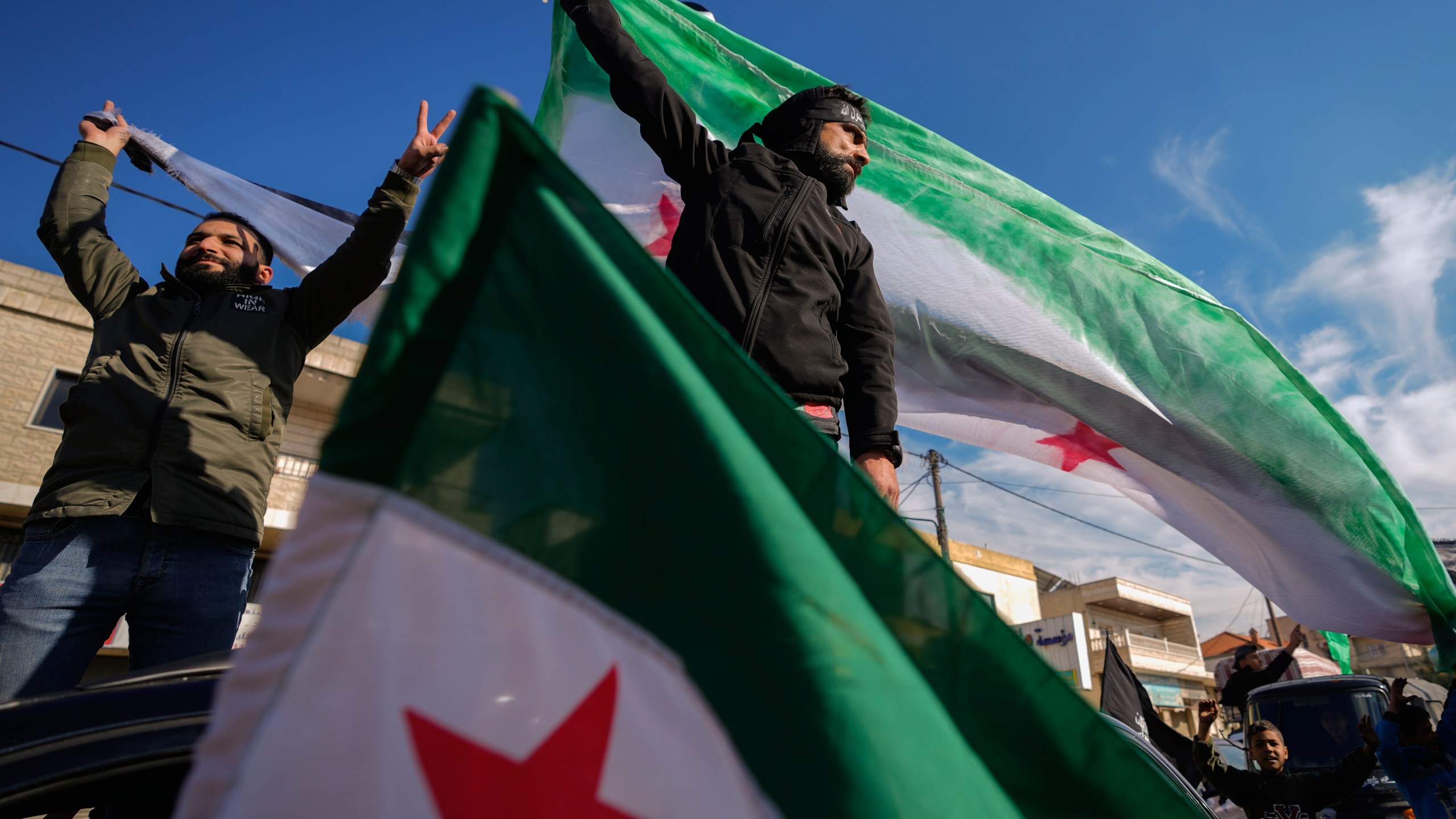 Syrians celebrate the fall of Bashar al-Assad's government.