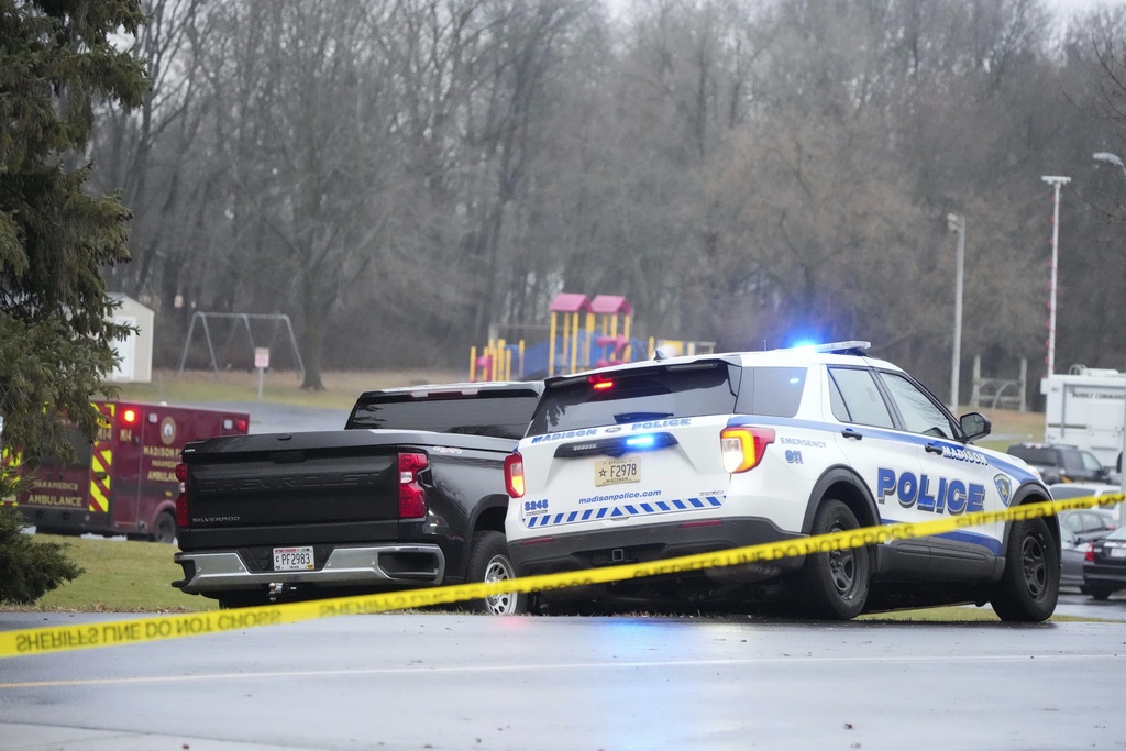Emergency vehicles are parked outside the Abundant Life Christian School in Madison, Wis.