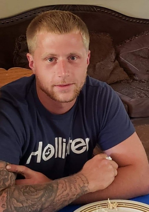 A blond man looking at the camera