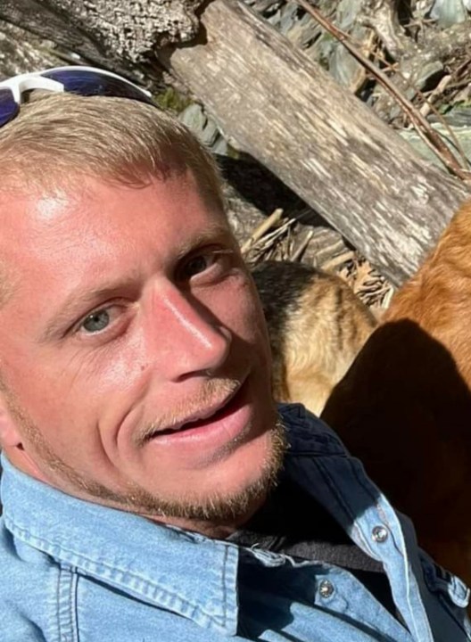 A blond man looking at the camera