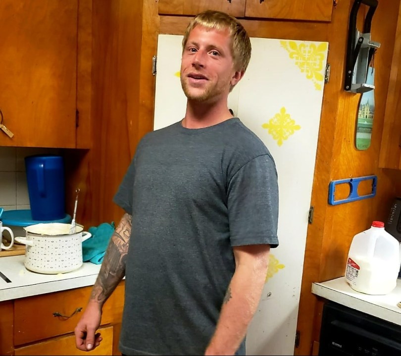 A blond man in a house