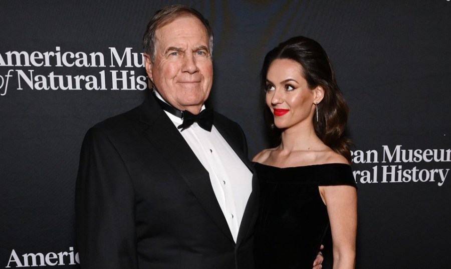 Bill Belichick and Jordon Hudson pose for photos at an event