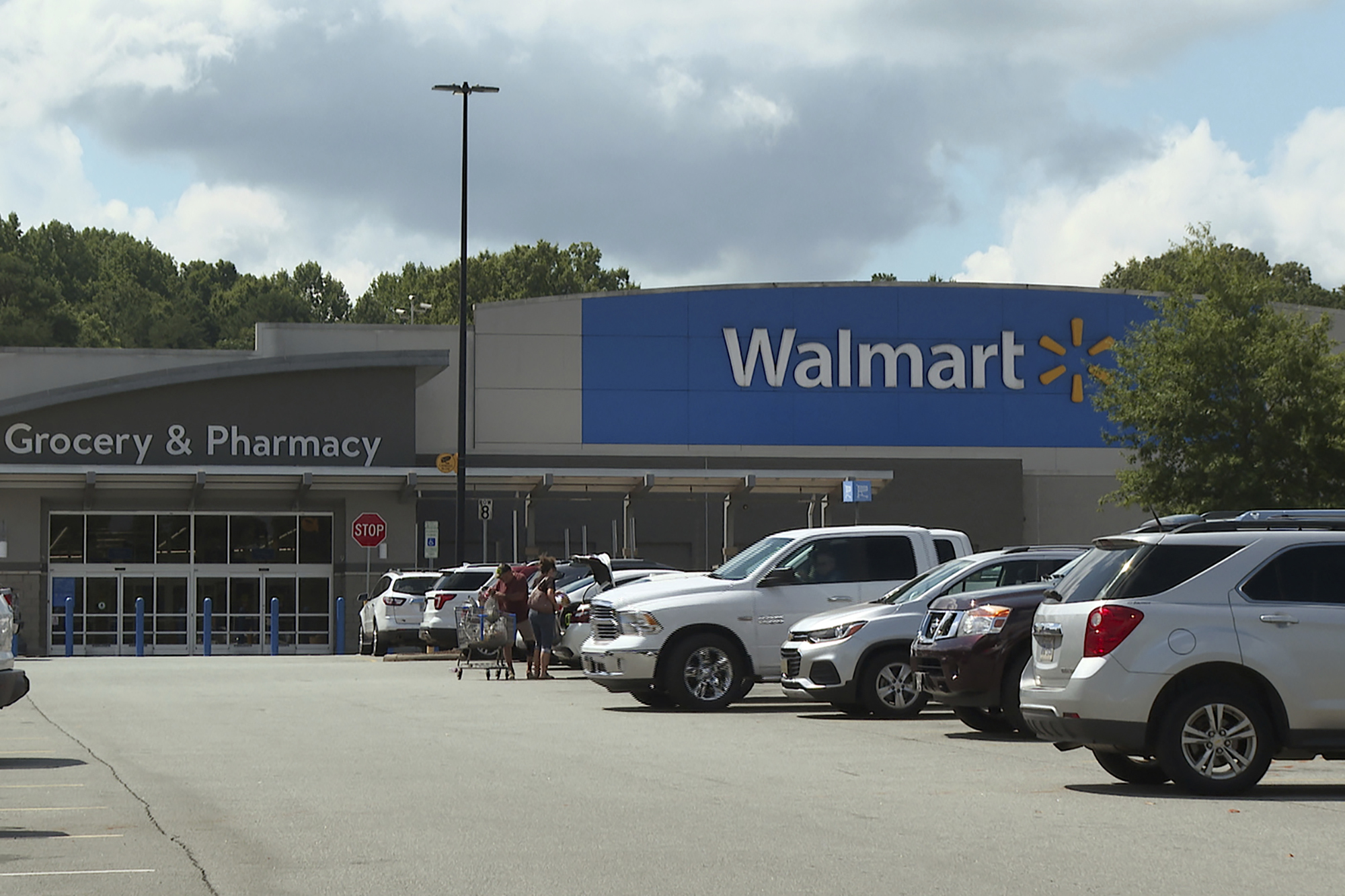 shoppers load purchased items into their vehicle at a Walmart