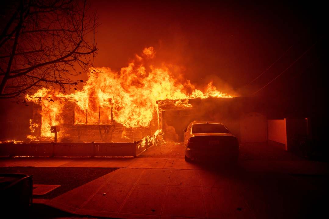 A home burning in the Palisades Fire