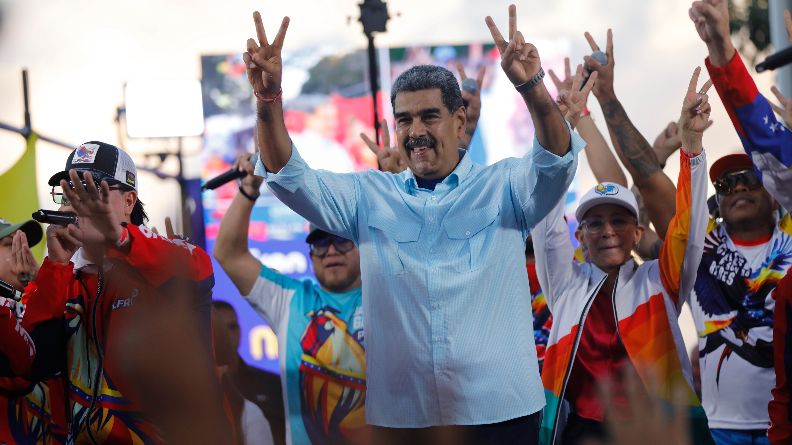 FILE - Venezuelan President Nicolas Maduro flashes victory hand signs at supporters during a pro-government rally, in Caracas, Venezuela, Aug. 17, 2024. (AP Photo/Cristian Hernandez, File)