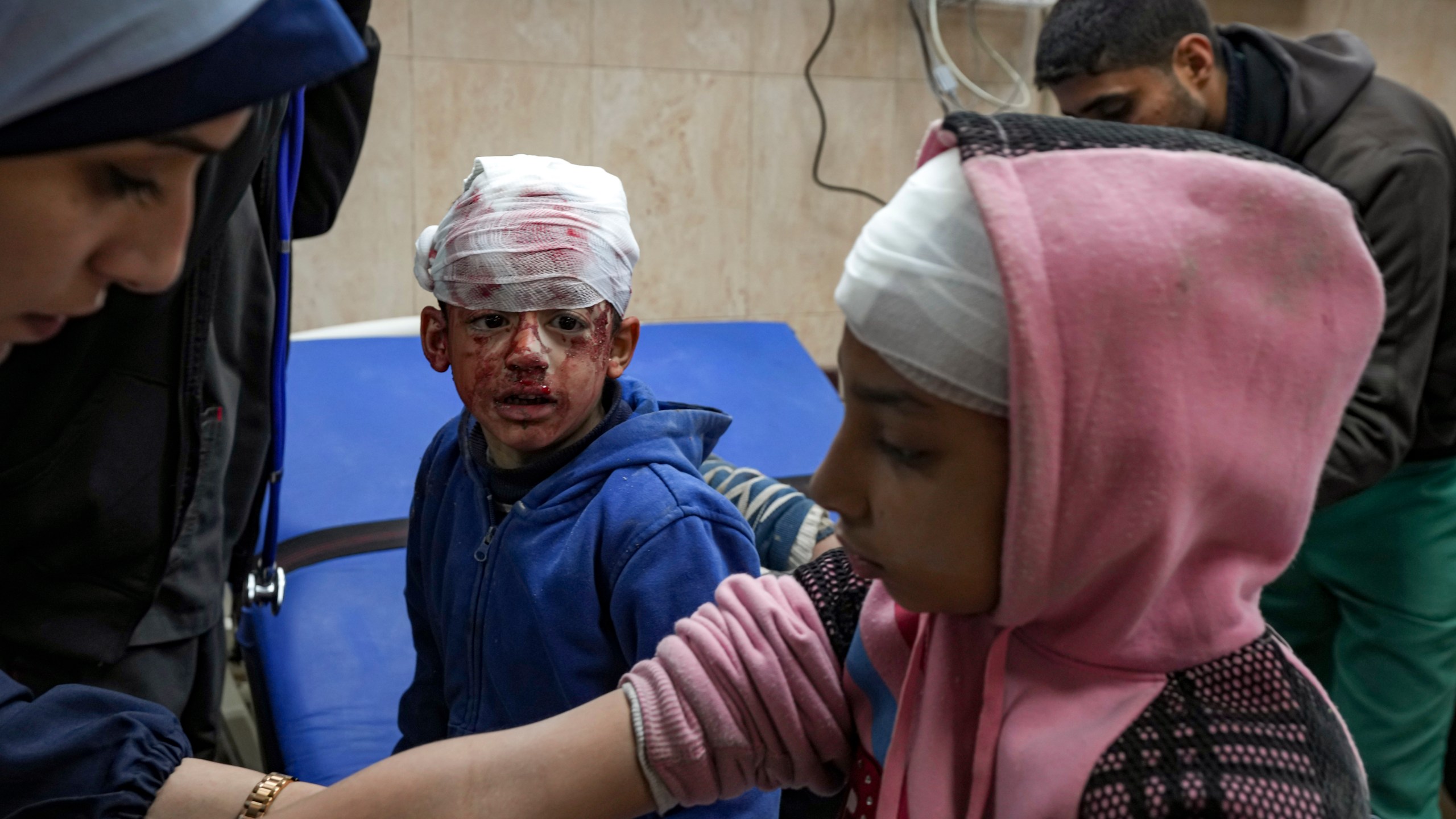 Palestinian children wounded during the Israeli bombardment of the Gaza Strip receive treatment at the Al-Aqsa Hospital in Deir al-Balah, Tuesday, Jan. 14, 2025. (AP Photo/Abdel Kareem Hana)