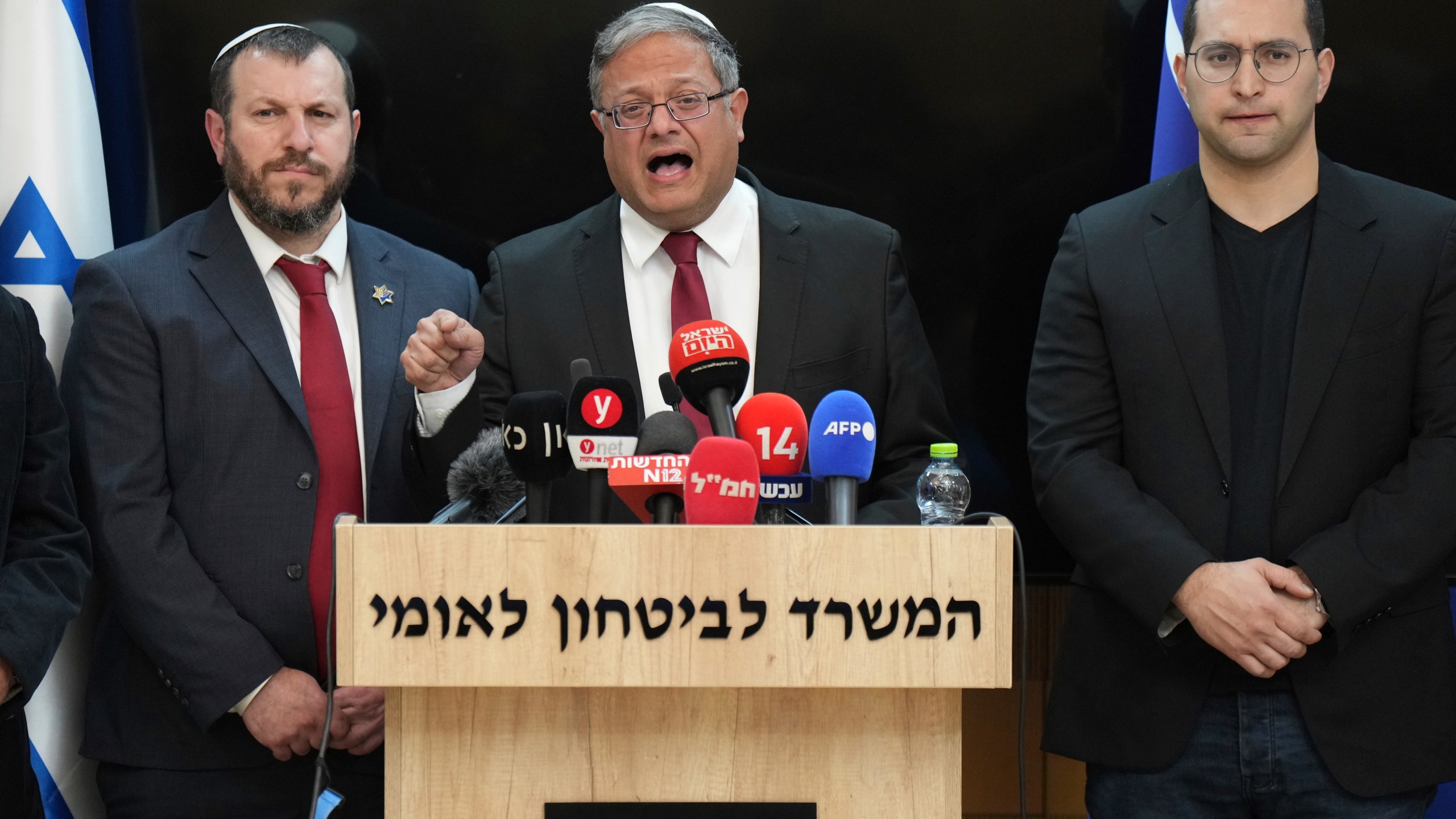 Israel's far-right National Security Minister, Itamar Ben-Gvir, center, in a statement to the media, says he will quit if Israel approves Gaza ceasefire, at his office in Jerusalem on Thursday, Jan. 16, 2025. (AP Photo/Ohad Zwigenberg)