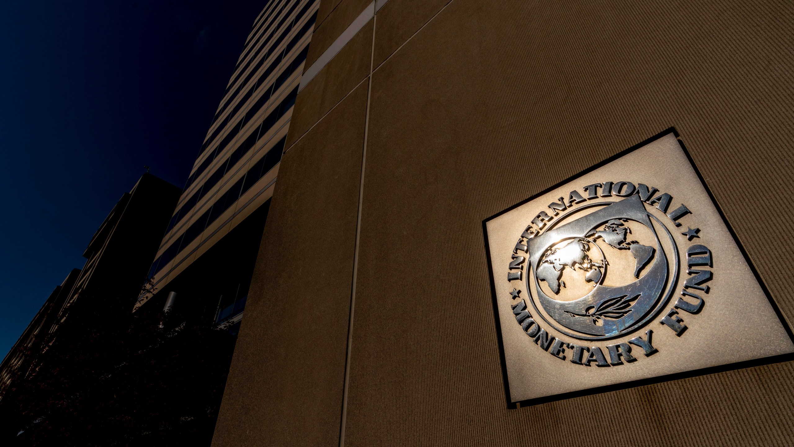 FILE - The International Monetary Fund building, Monday, April 5, 2021, in Washington. (AP Photo/Andrew Harnik, File)