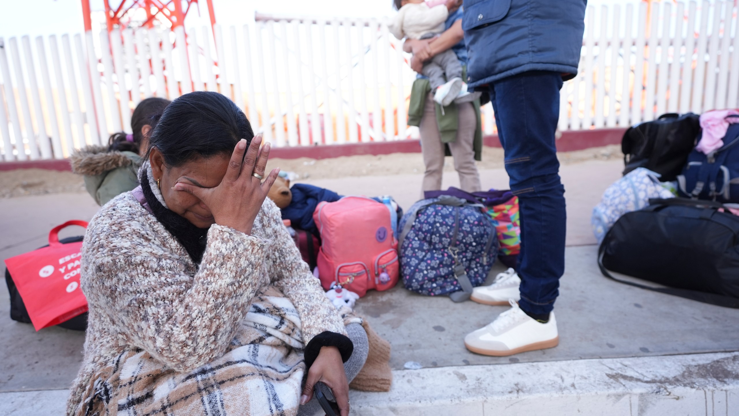 CORRECTS COUNTRY SPELLING Maria Mercado, who is from Colombia but arrived from Ecuador, gets emotional as she sees that her 1pm appointment was canceled on the U.S. Customs and Border Protection (CBP) One app, as she and her family wait at the border crossing in Tijuana, Mexico on Monday, Jan. 20. 2025. (AP Photo/Gregory Bull)
