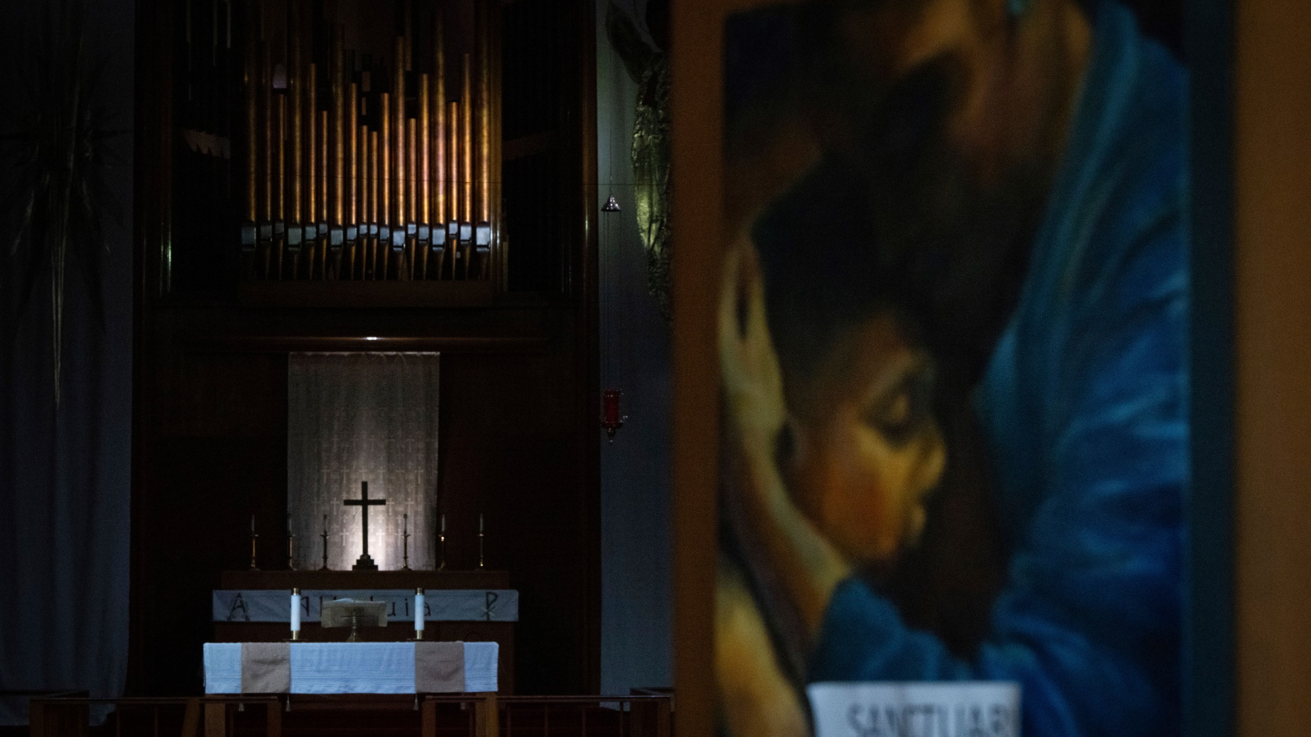A painting with the word "sanctuary" on it is displayed on the doors of the Augustana Lutheran Church on Thursday, Jan. 9, 2025, in Portland, Ore. (AP Photo/Jenny Kane)