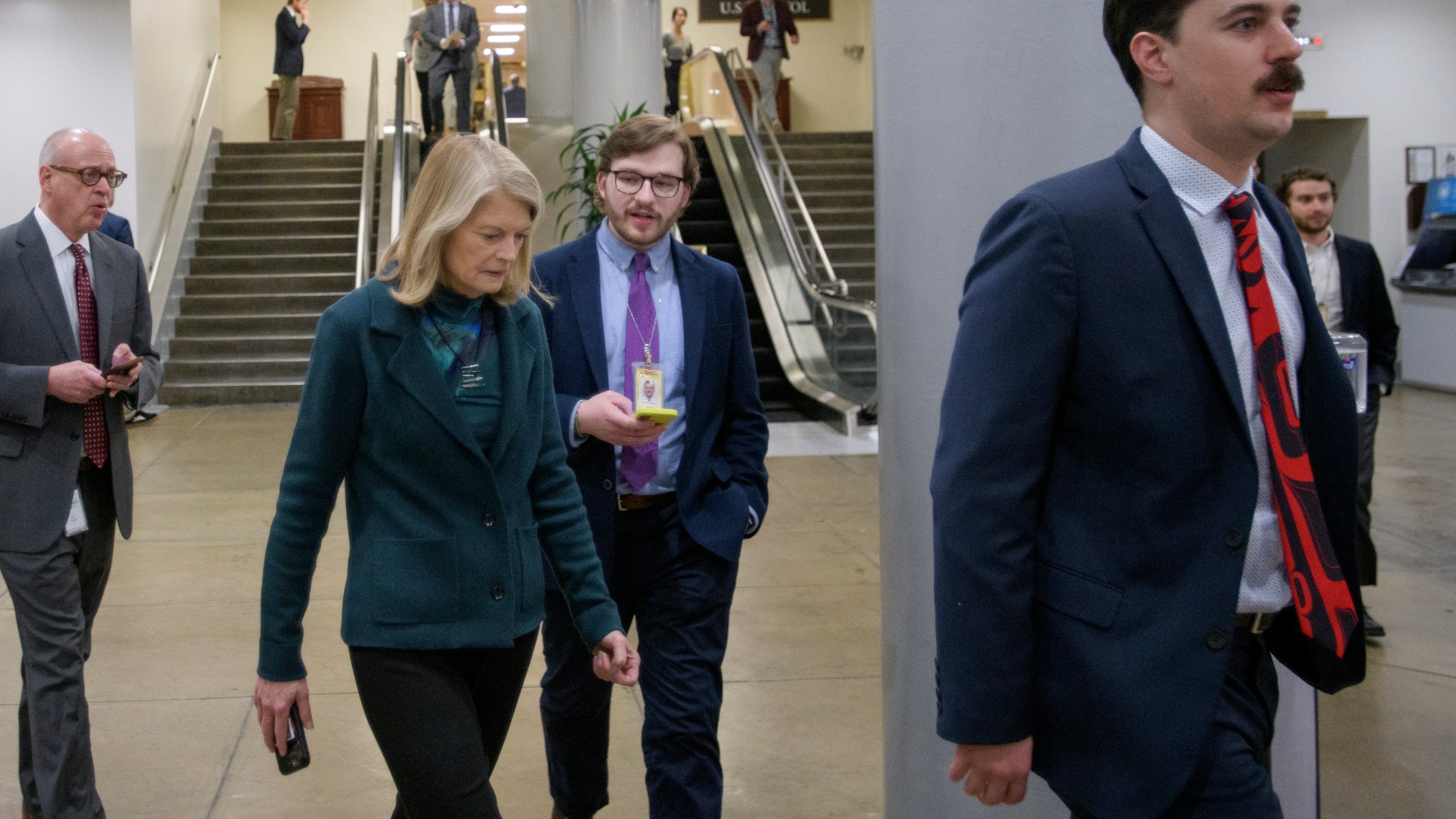 Sen. Lisa Murkowski, R-Alaska, talks with reporters as she makes her way through the Senate subway at the Capitol, Thursday, Jan. 23, 2025, in Washington. (AP Photo/Rod Lamkey, Jr.)