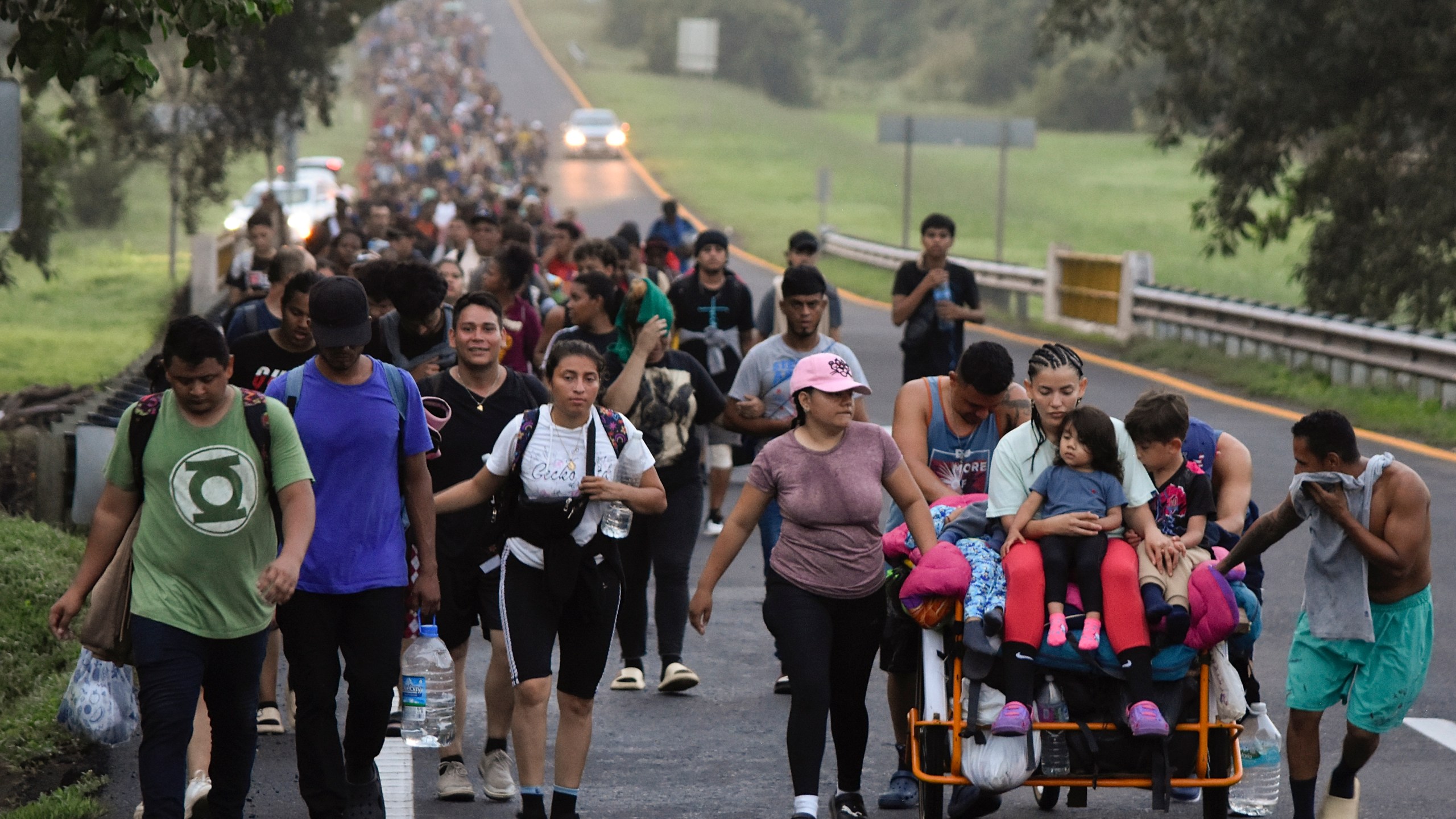 FILE - Migrants walk along the Huixtla highway in the state of Chiapas, Mexico, Oct. 22, 2024, hoping to reach the country's northern border and ultimately the United States. (AP Photo/Edgar H. Clemente, File)