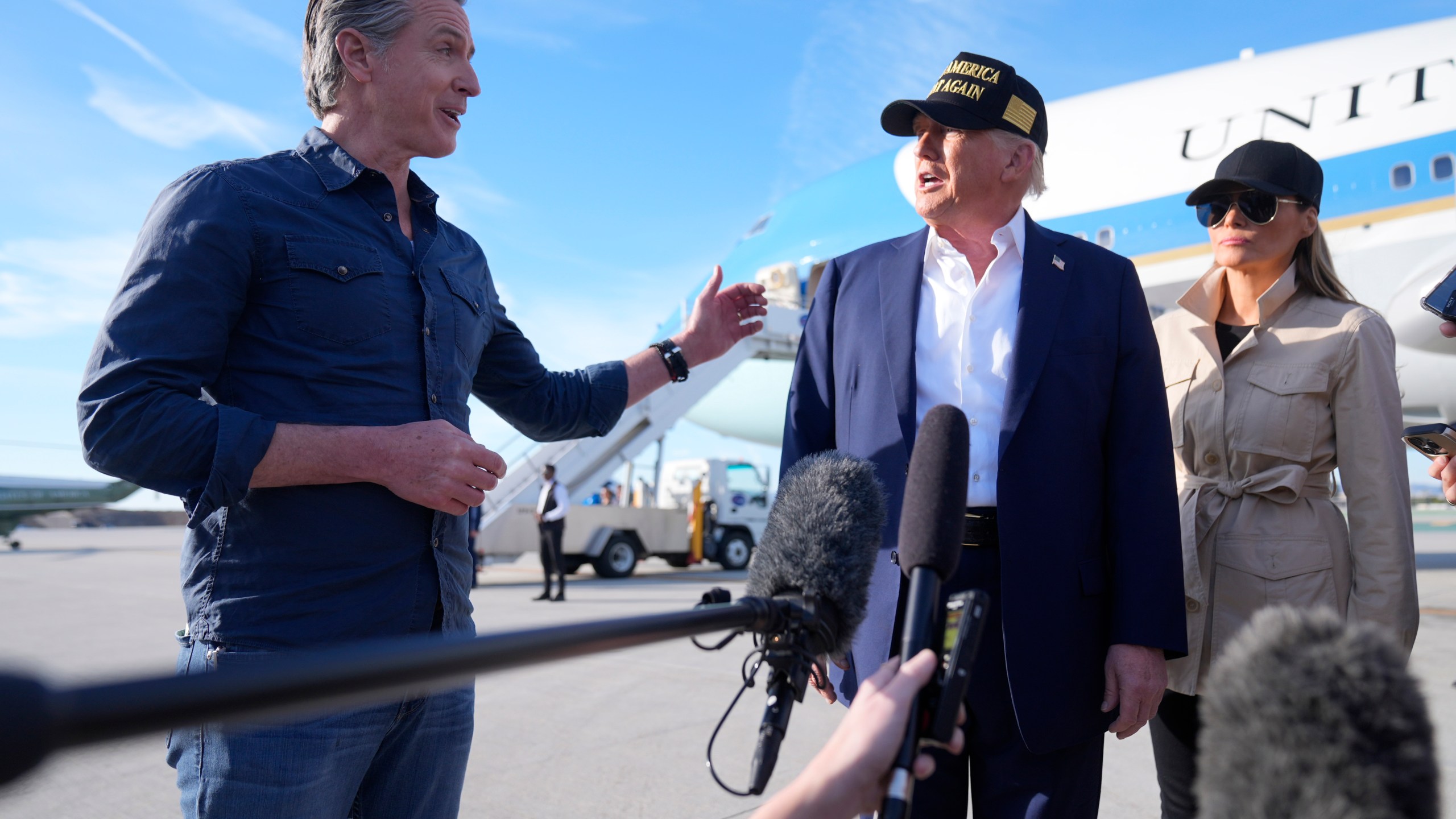 President Donald Trump and first lady Melania Trump listen to California Gov. Gavin Newsom after arriving on Air Force One at Los Angeles International Airport in Los Angeles, Friday, Jan. 24, 2025. (AP Photo/Mark Schiefelbein)
