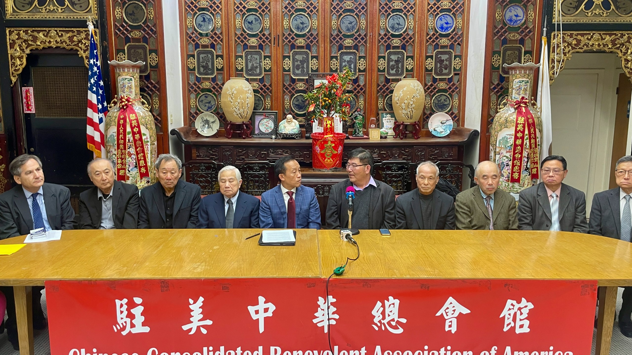 Members of the Chinese Consolidated Benevolent Association of America sit during a news conference in the Chinatown district of San Francisco on Friday, Jan. 24, 2025. (AP Photo/Haven Daley)