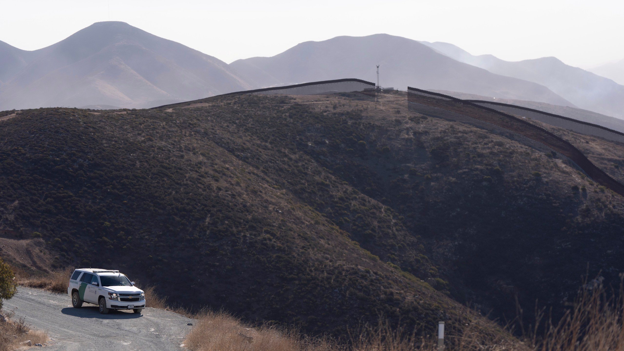 A Border Patrol vehicle sits near two border walls separating Mexico from the United States, Thursday, Jan. 23, 2025, in San Diego. (AP Photo/Gregory Bull)