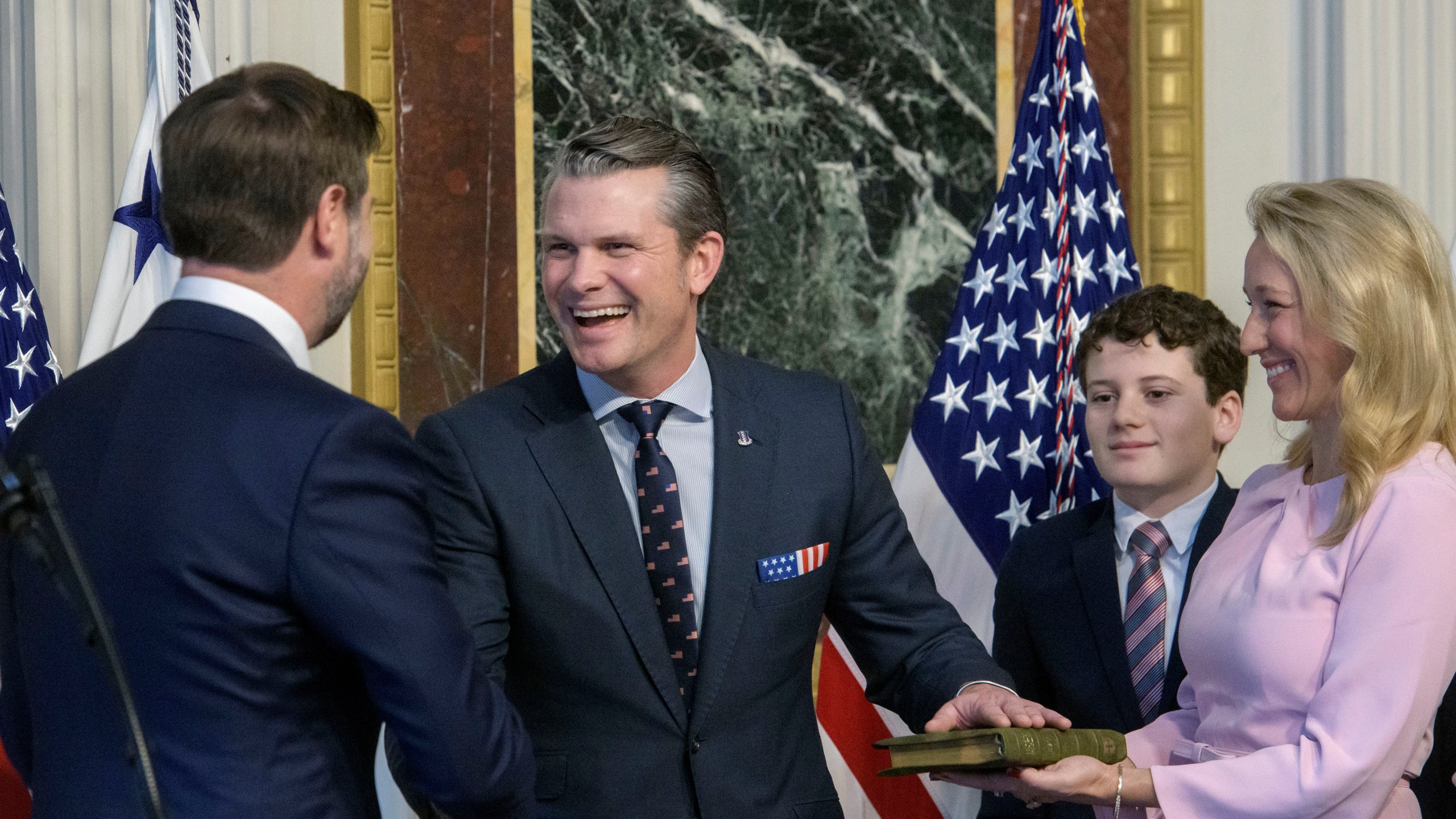 Vice President JD Vance, from left, swears in Pete Hegseth to be Secretary of Defense as his wife Jennifer Rauchet holds the Bible and Hegseth's son watches in the Indian Treaty Room of the Eisenhower Executive Office Building on the White House campus in Washington, Saturday, Jan. 25, 2025. (AP Photo/Rod Lamkey, Jr.)